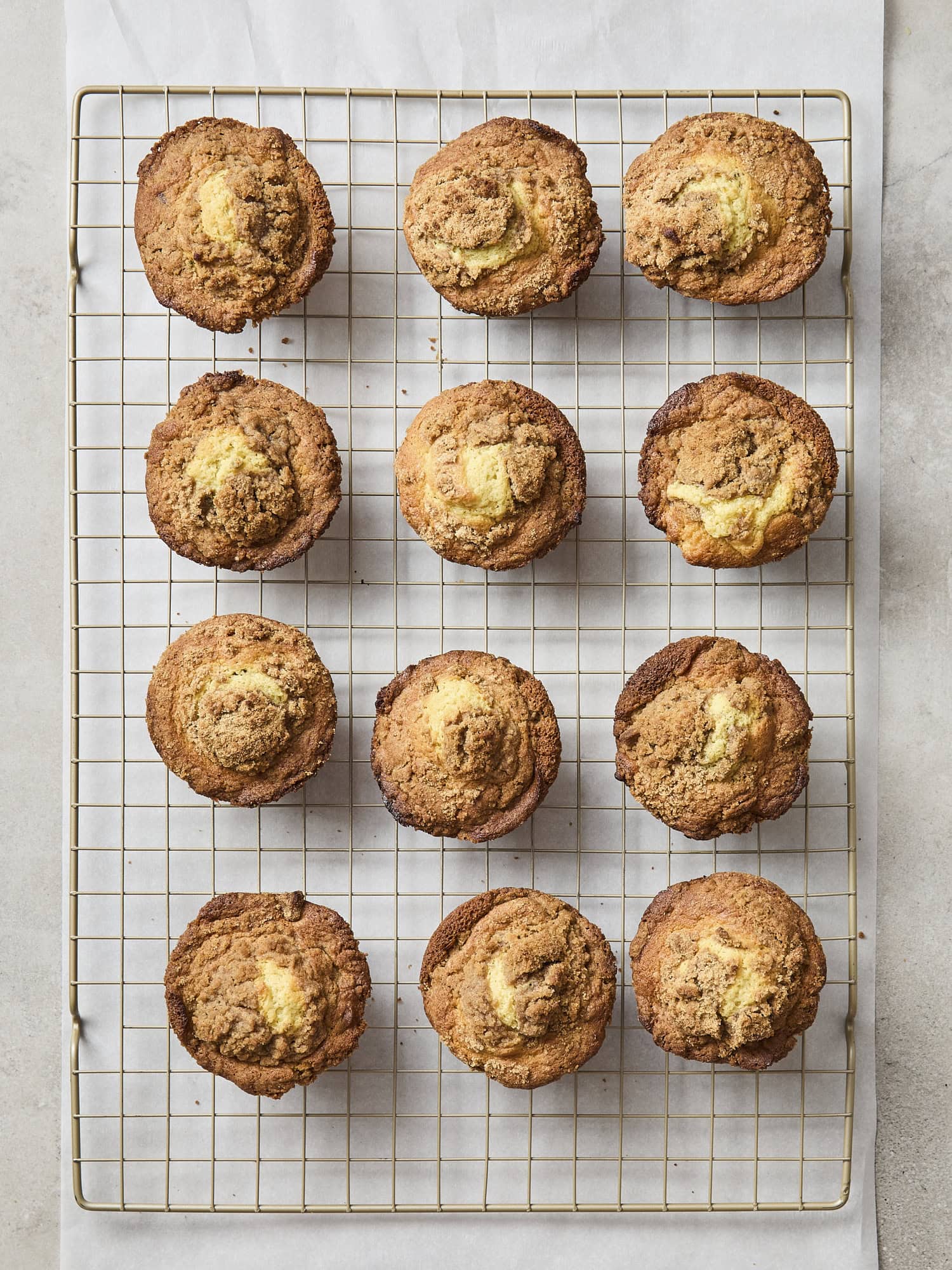 Baked pistachio muffins cooling on a rack.