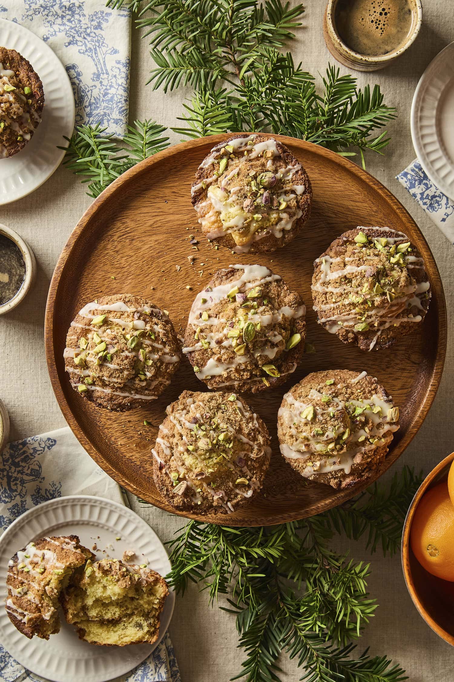 Plate filled with pistachio muffins with one broken open to show texture.
