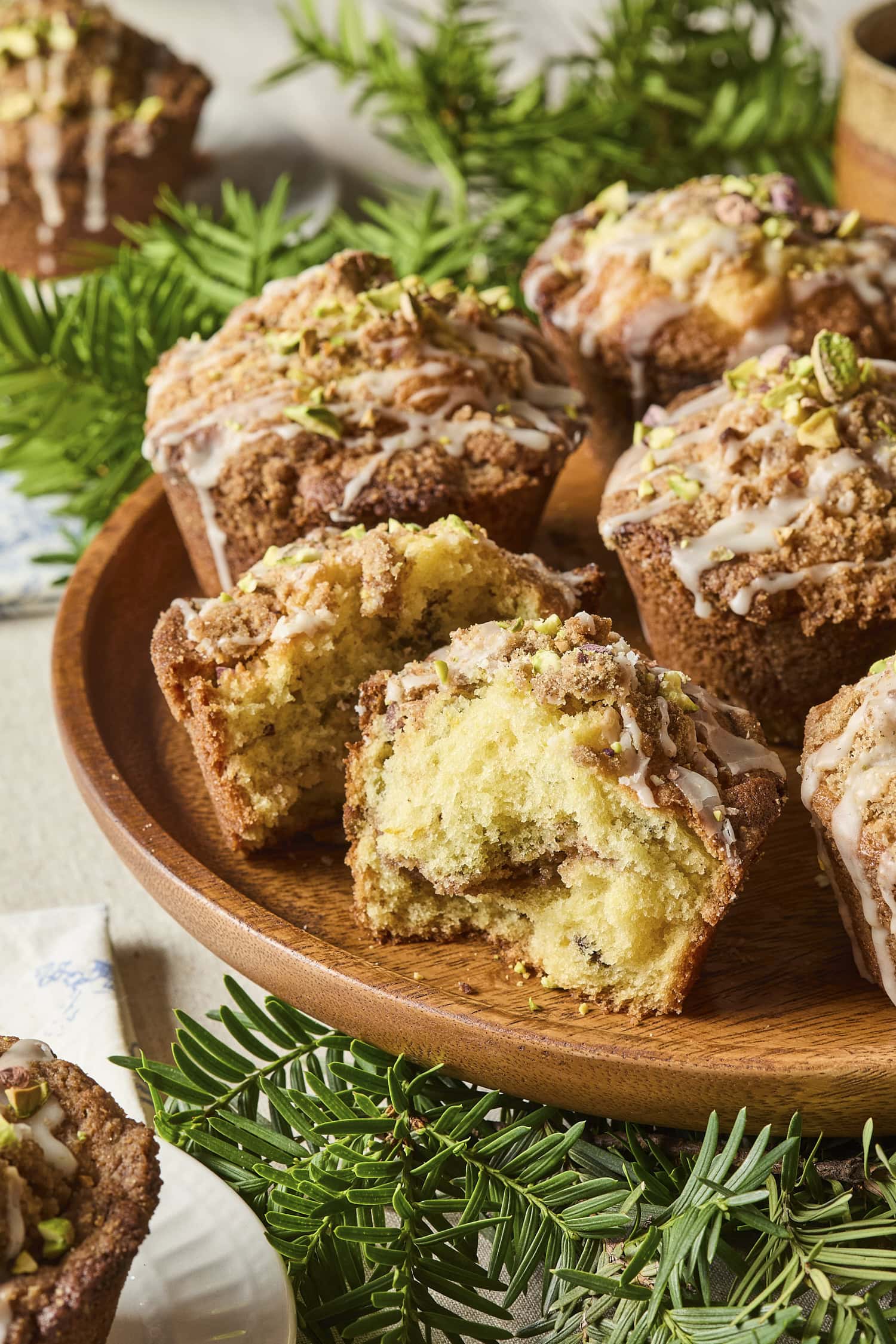 Broken apart muffin showing interior texture including cardamom crumb.