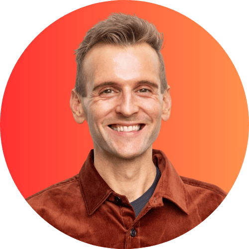 Kaleb Wyse standing in front of ombre orange to red background.