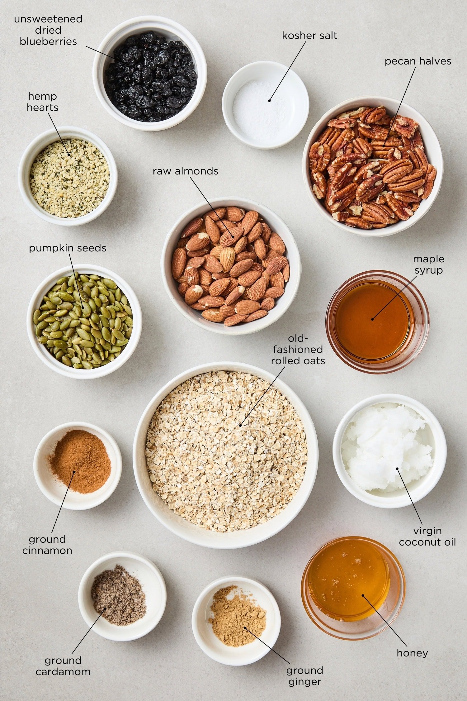 Concrete surface with ingredients needed to make granola from scratch.