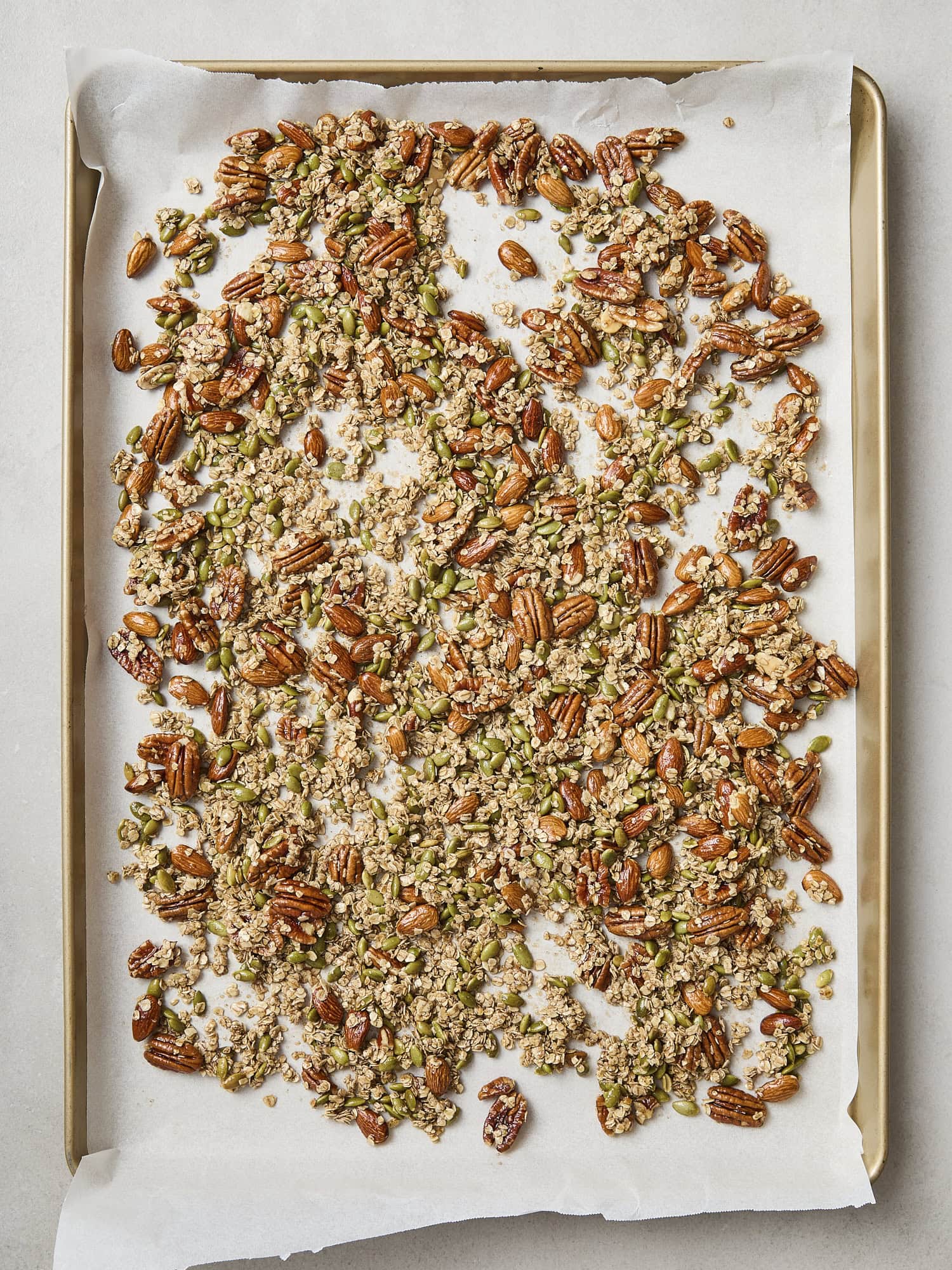 Baking sheet with granola mixture ready to be baked.