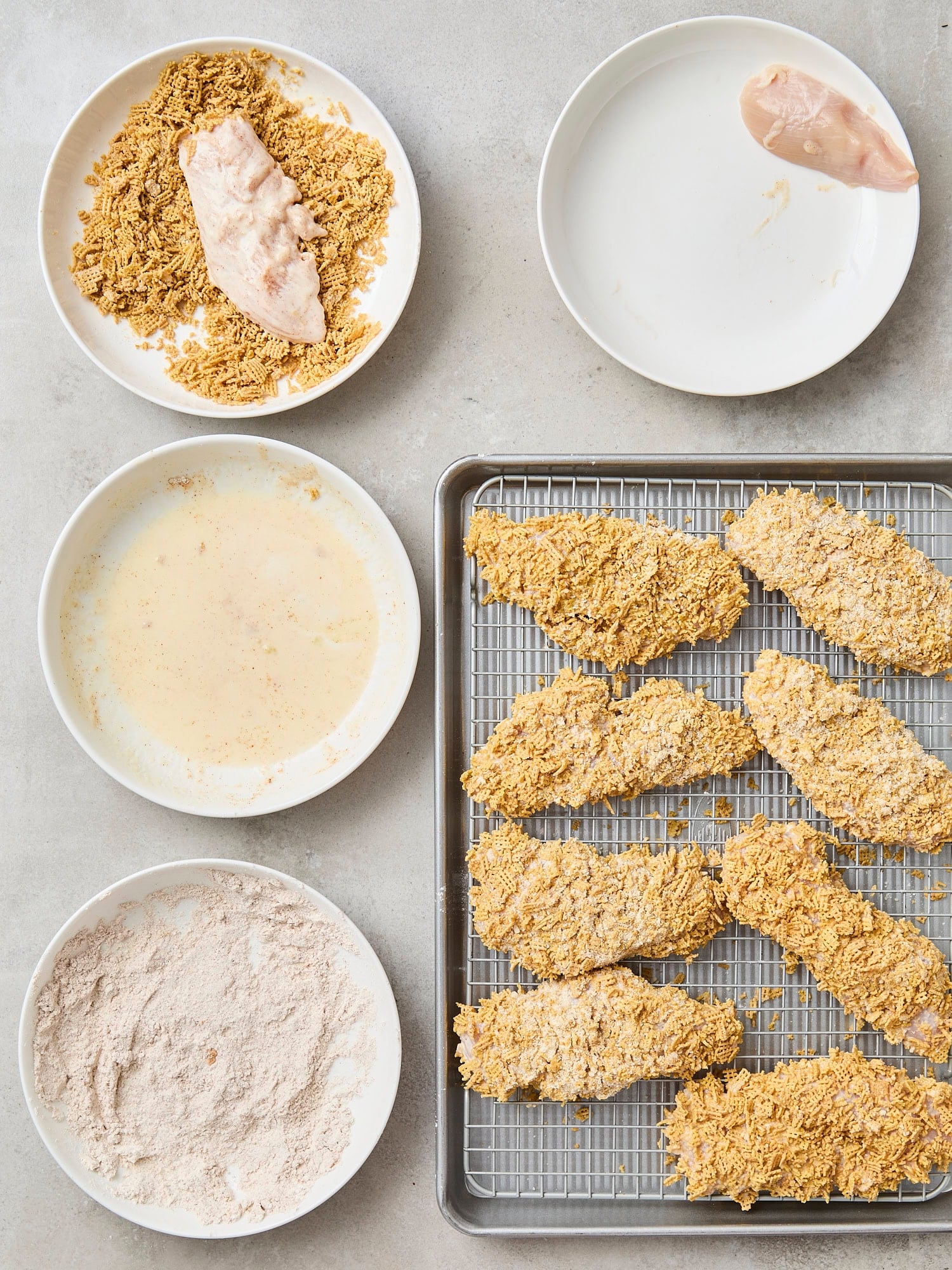 Three plates with dredging process for chicken strips.