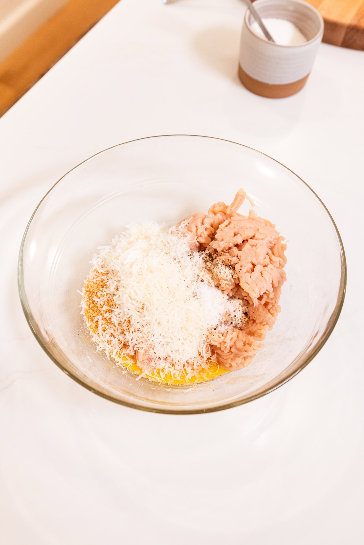 Ingredients in a bowl for chicken meatballs.