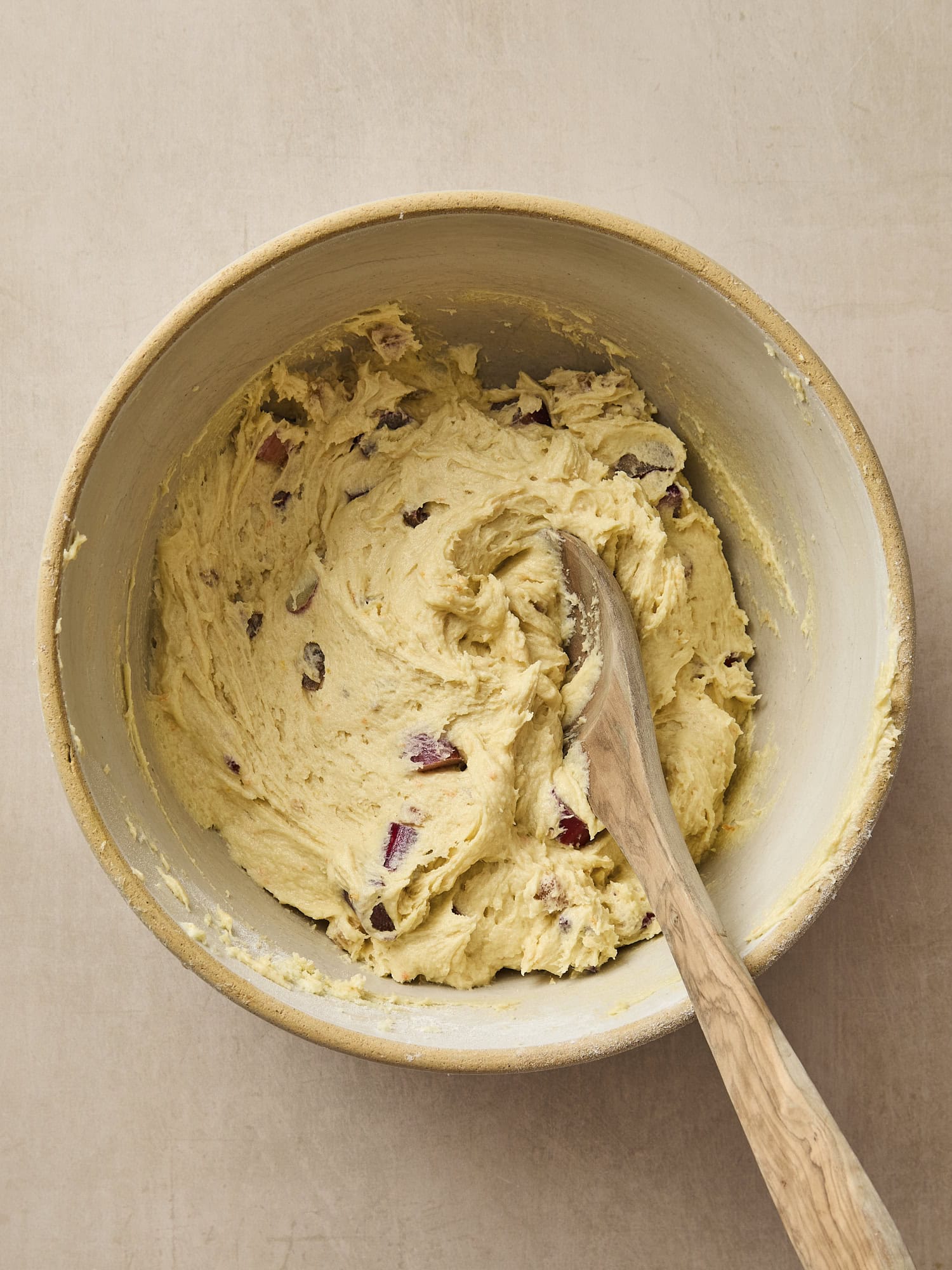 Bowl with rhubarb mixed into batter.
