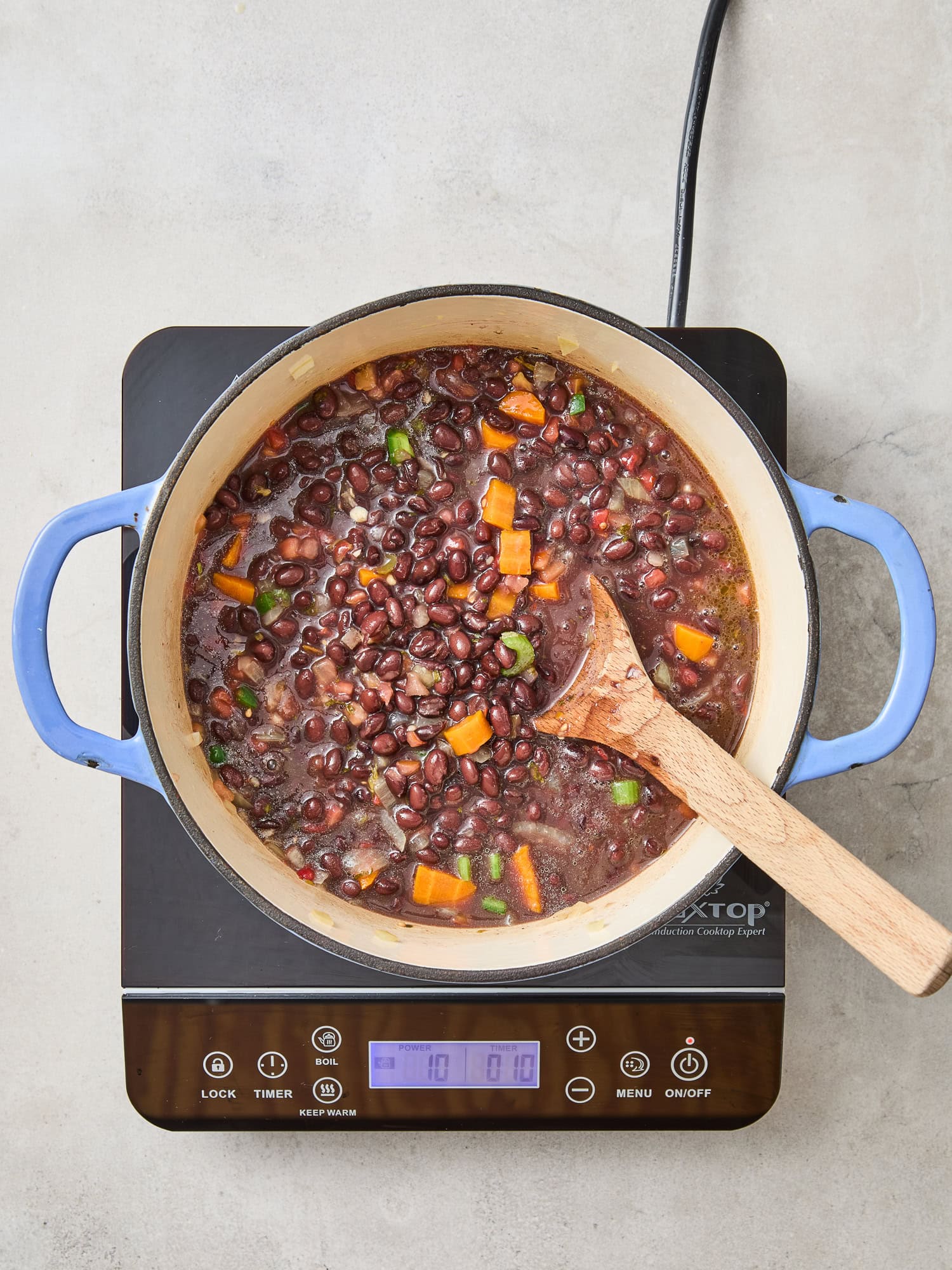Black bean soup simmering over heat.