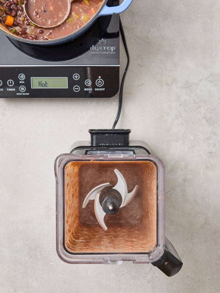 Blended vegetables and bean in a blender container.