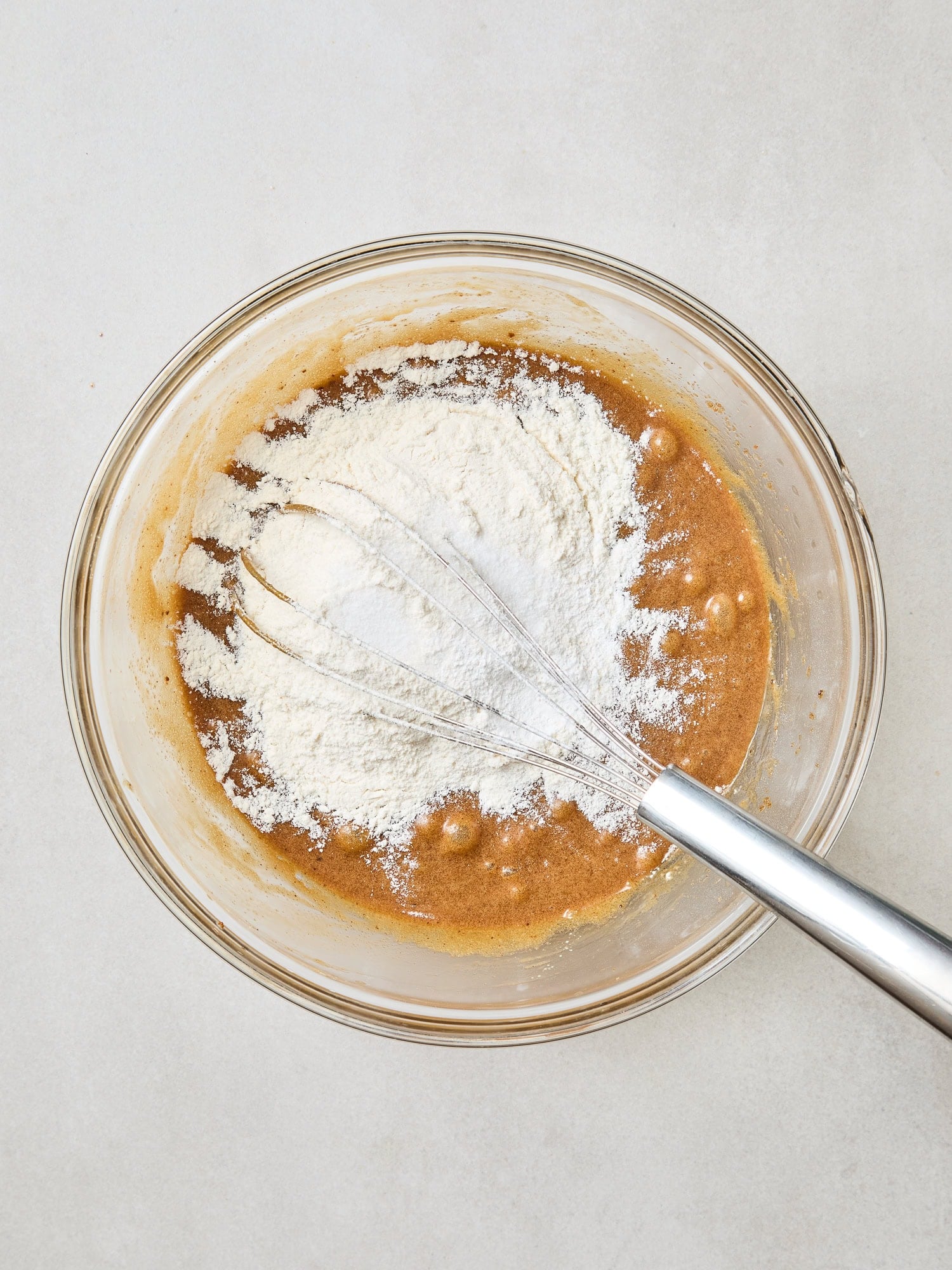 Dry ingredients being mixed into wet ingredients for a blondie batter.