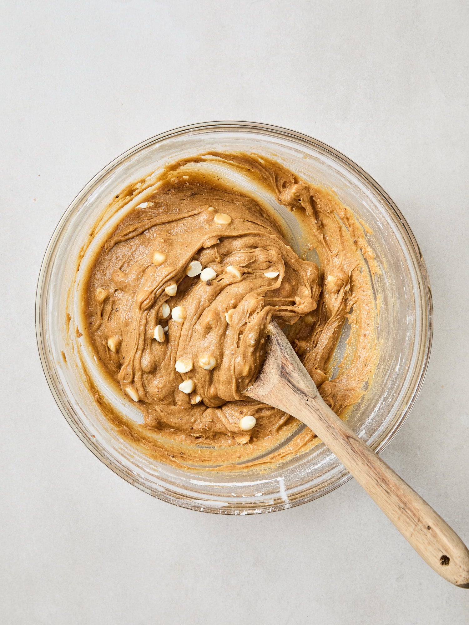 Folding white chocolate chips into brown butter blondie batter.