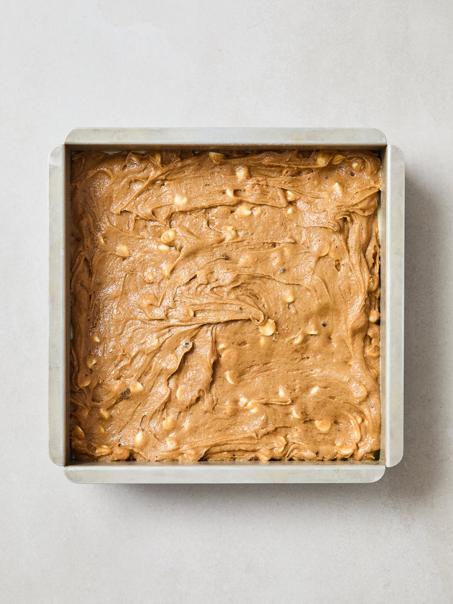 Blondie batter in a pan prior to baking.