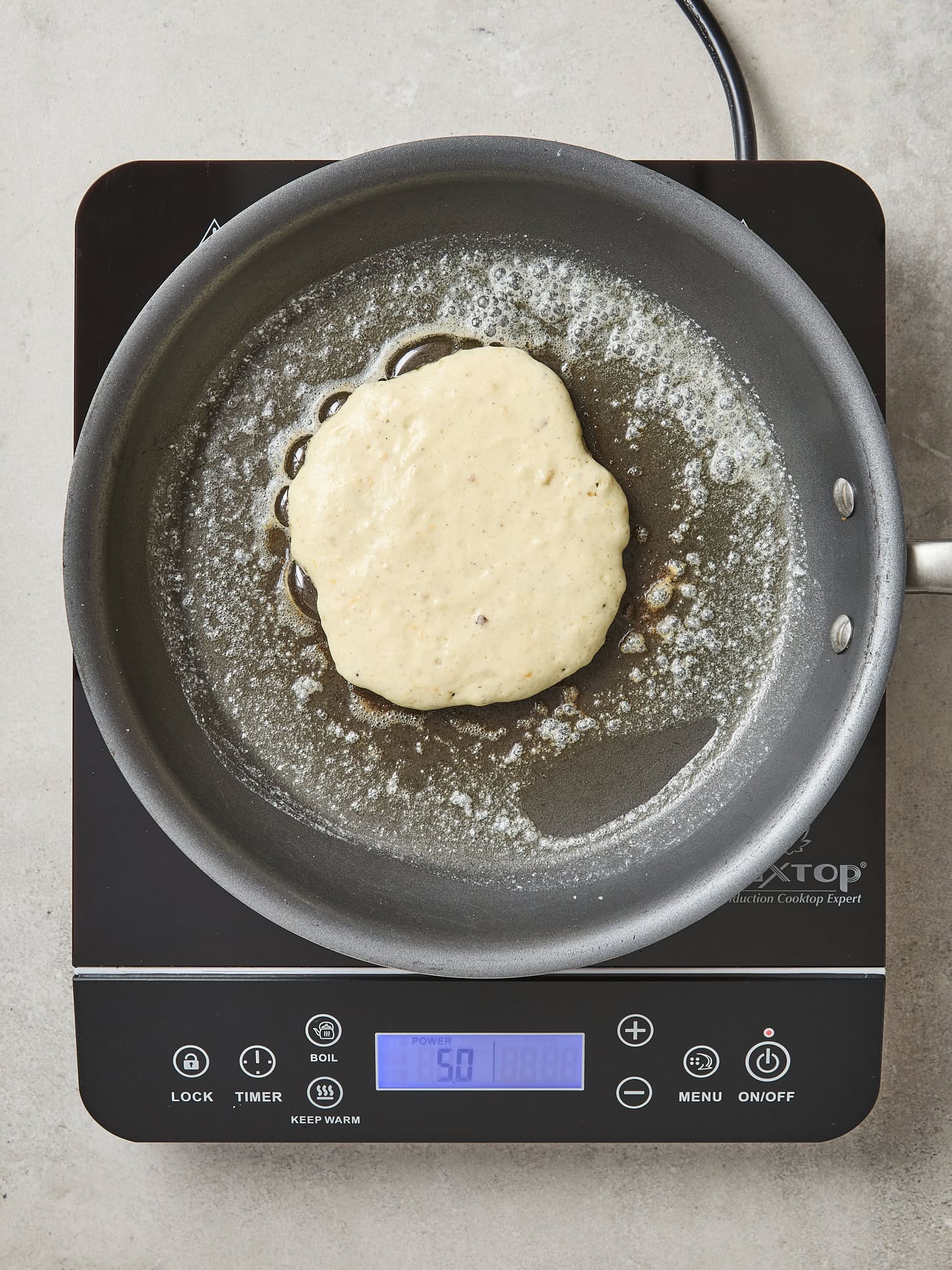 Uncooked pancake in a pan.