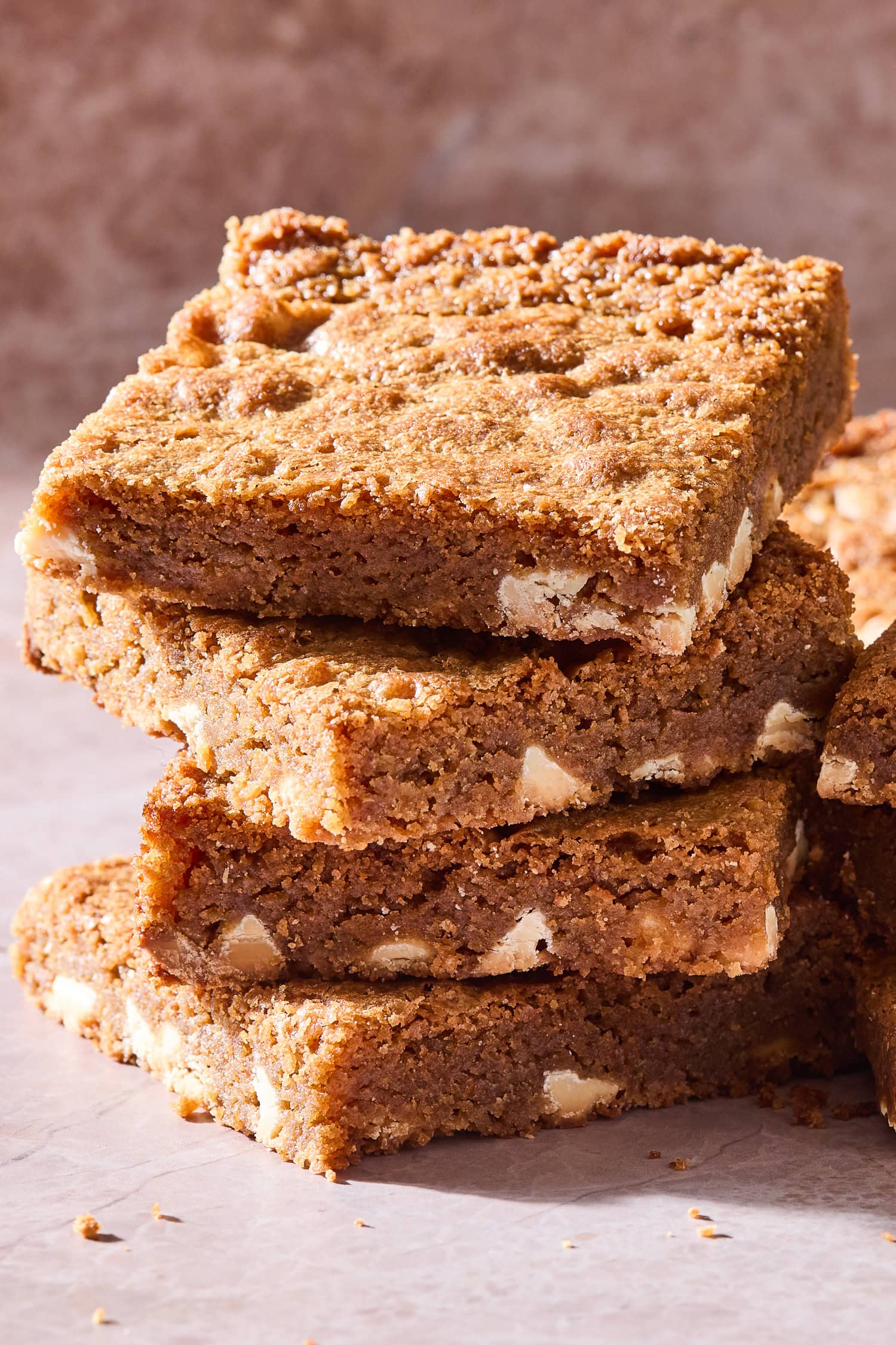 A stack of blondies with white chocolate chips.