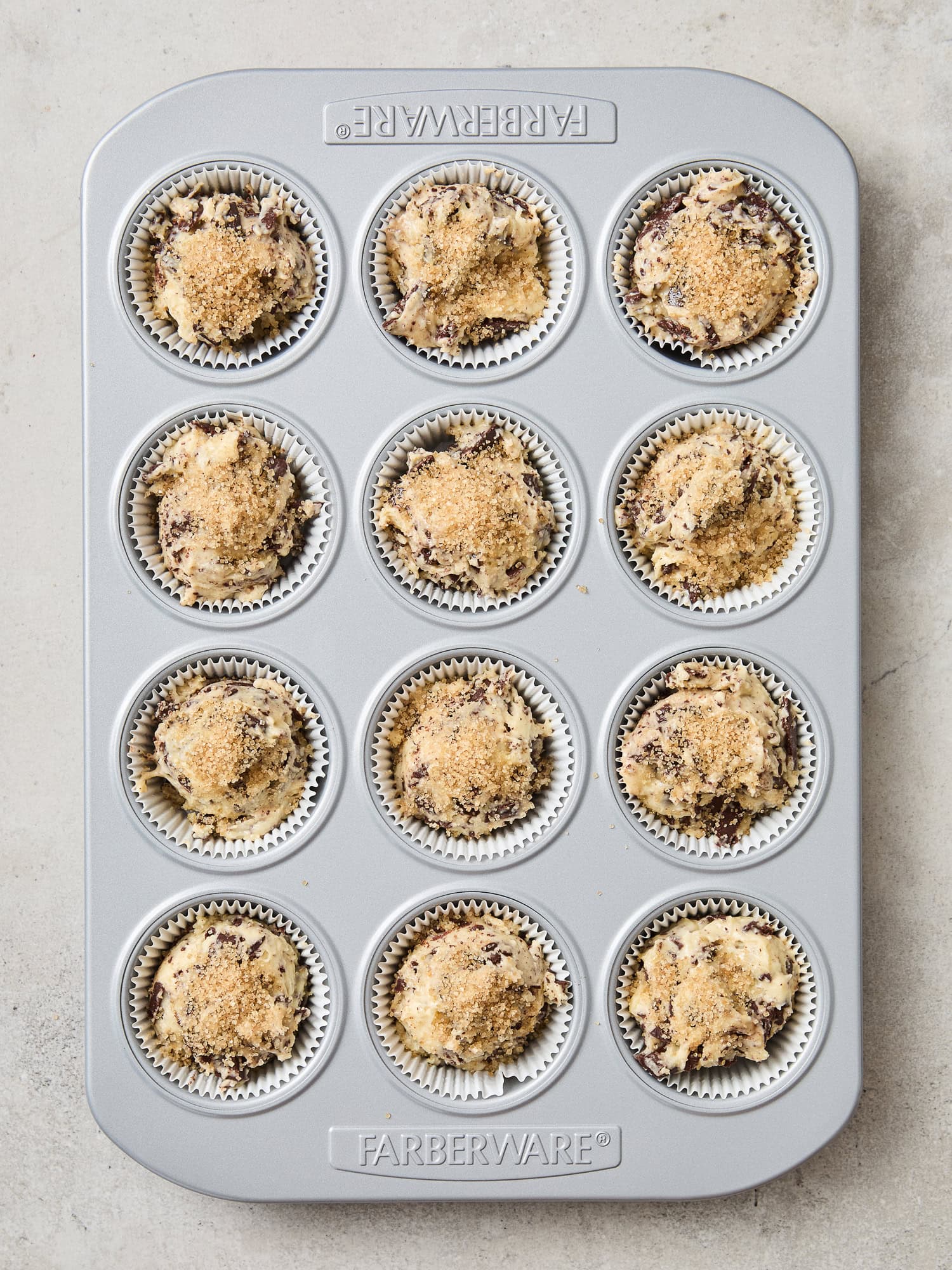 Muffin batter in a tin prior to baking.
