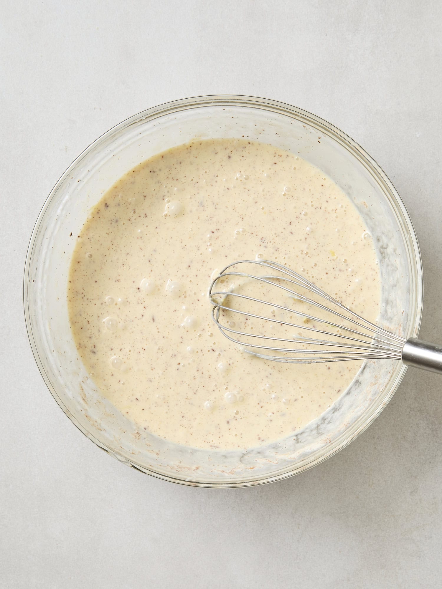 Glass bowl with custard for blueberry French toast.