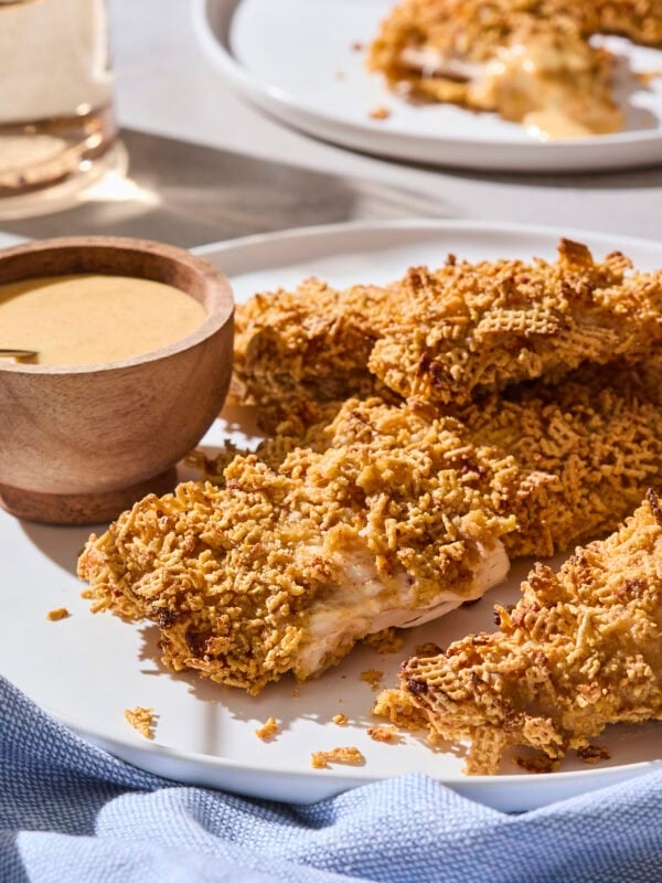 Pile of crispy chicken strips on a plate.