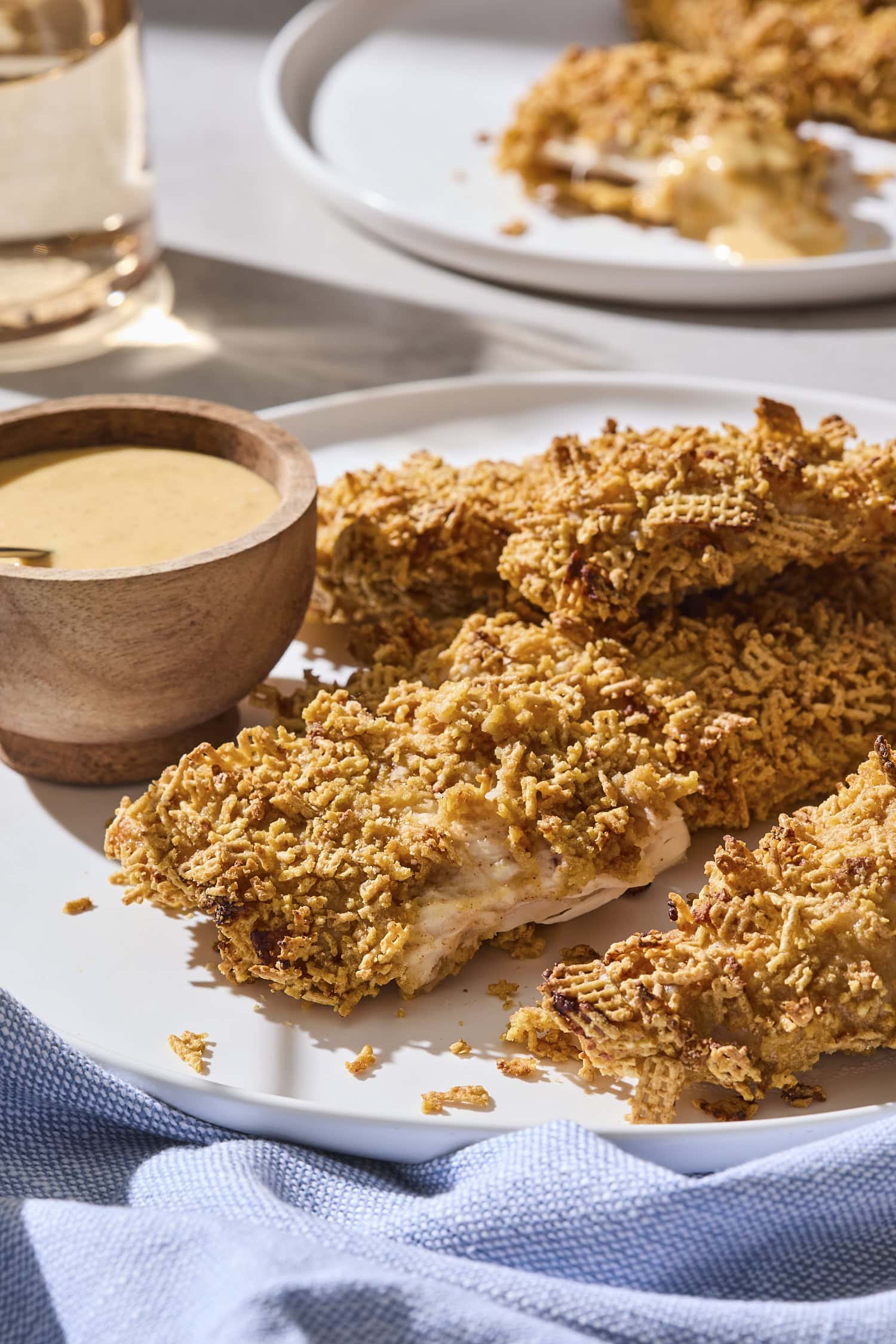 Pile of crispy chicken strips on a plate.