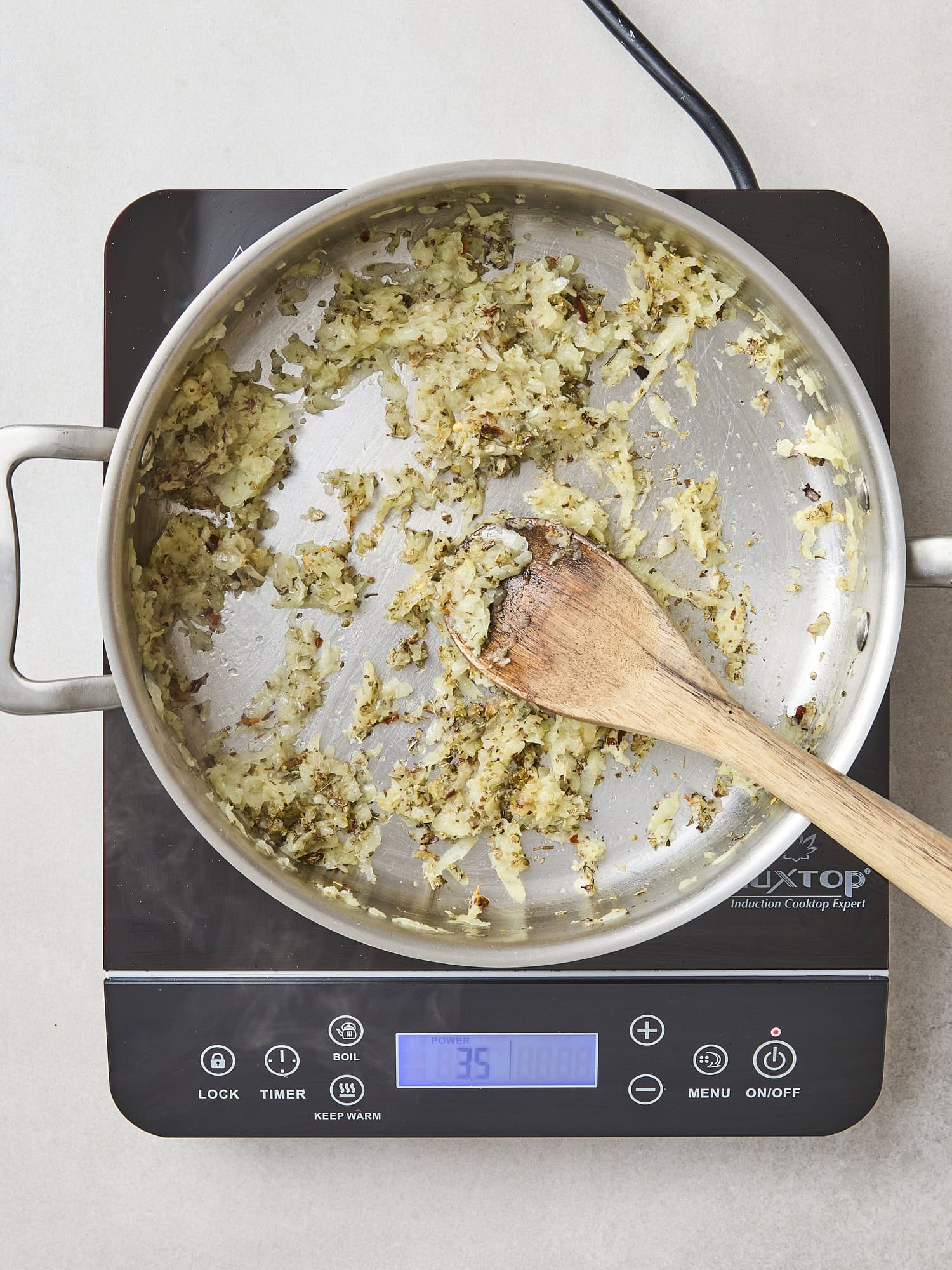 Saucepan with onion and garlic cooking with spices.