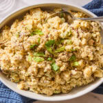 Potato salad in a large serving platter garnished with parsley.