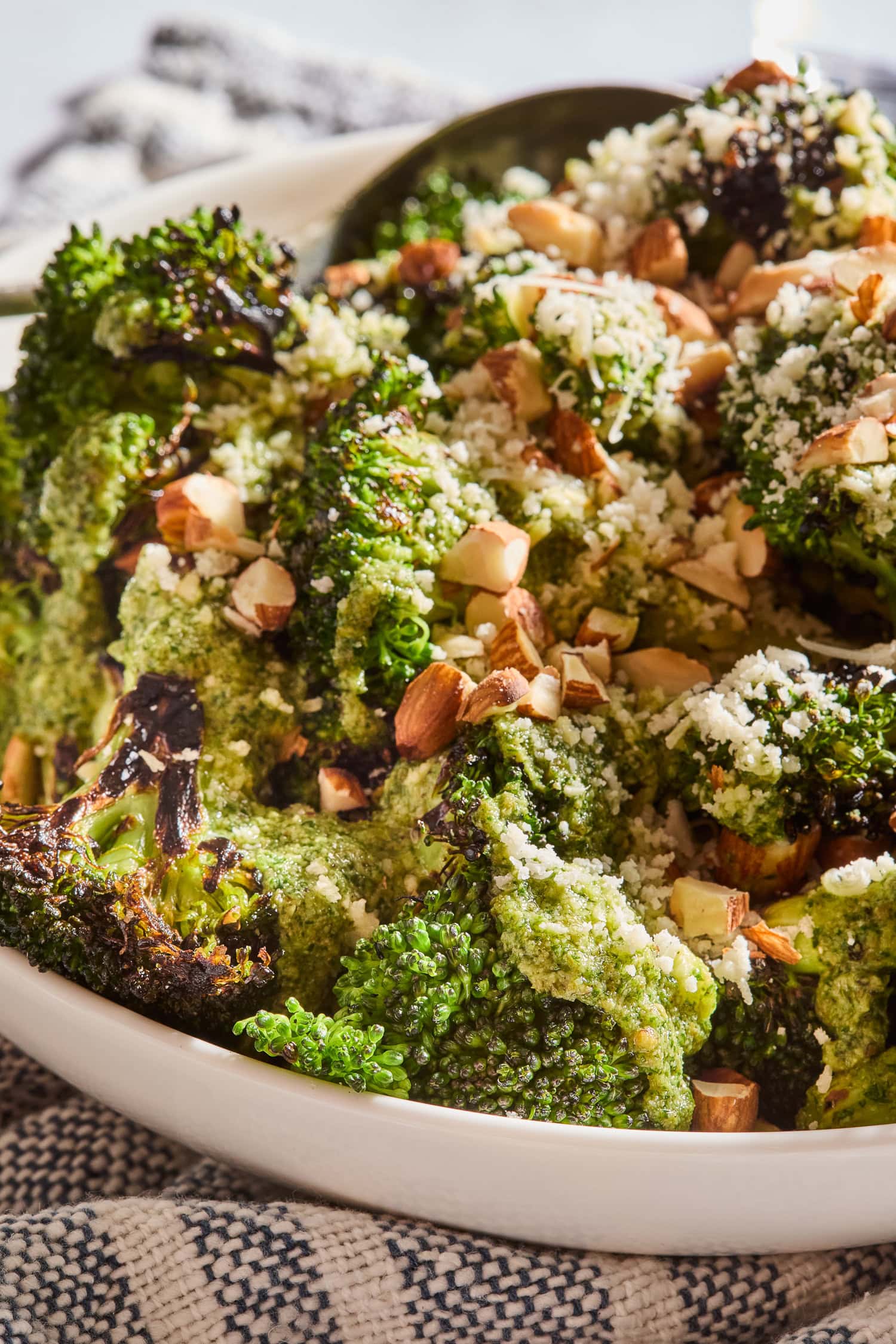 Toasted almonds and Parmesan cheese on top of roasted broccoli salad.