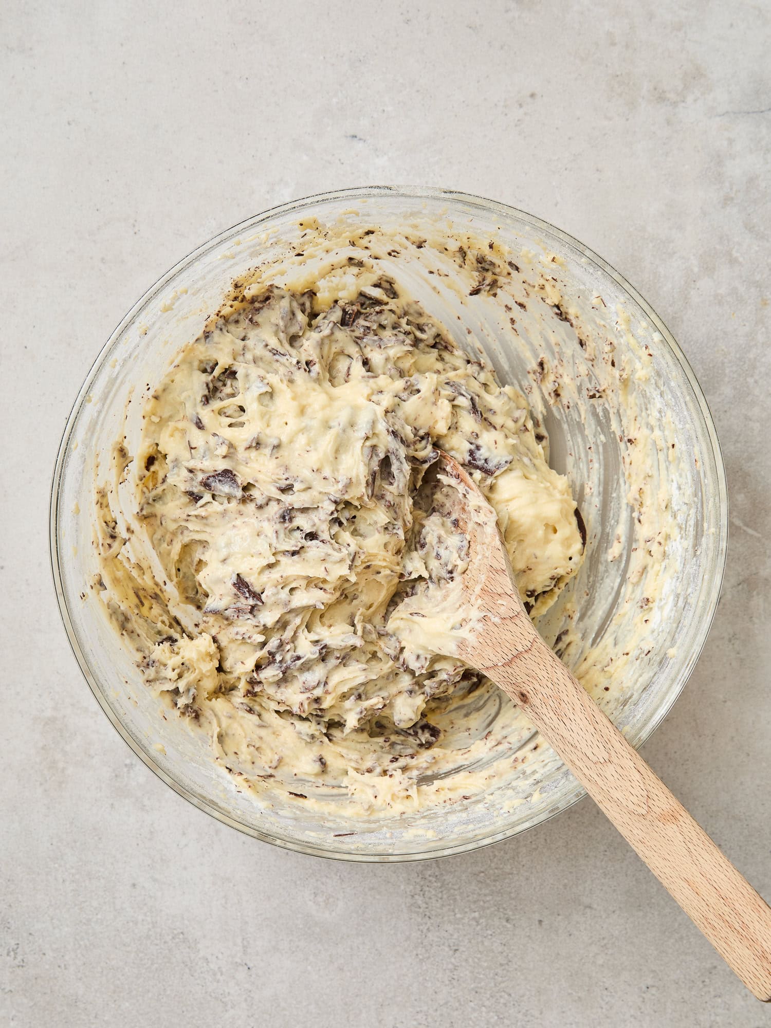 Muffin batter with folded pieces of shredded chocolate.