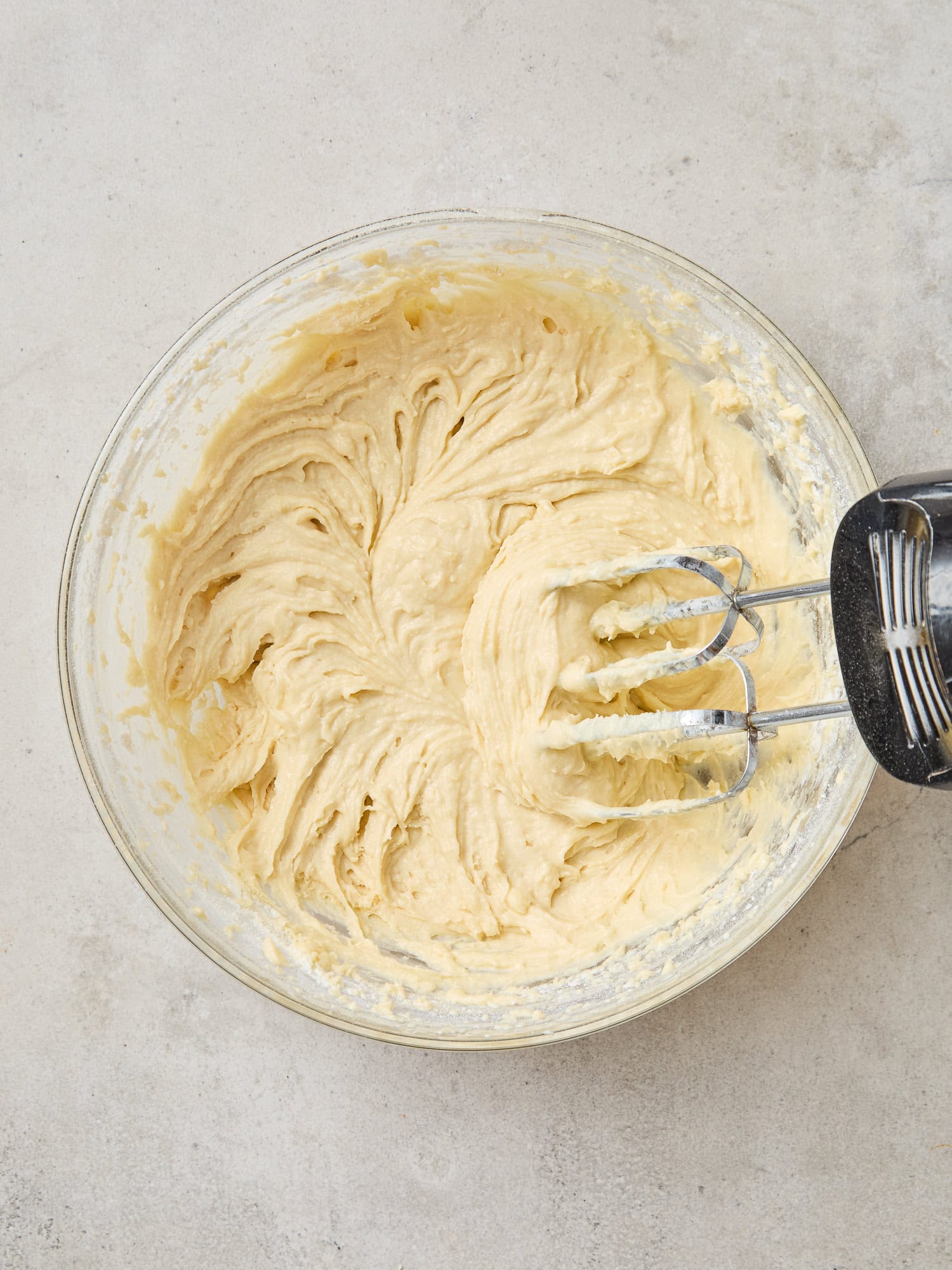 Mixing batter together in a glass bowl for muffins