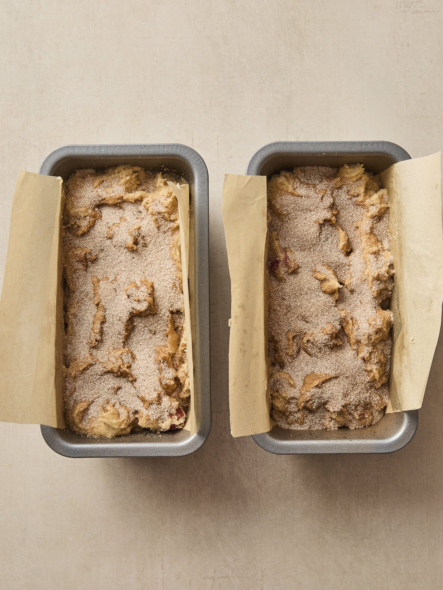 Two rhubarb cake loaves with cinnamon sugar topping.