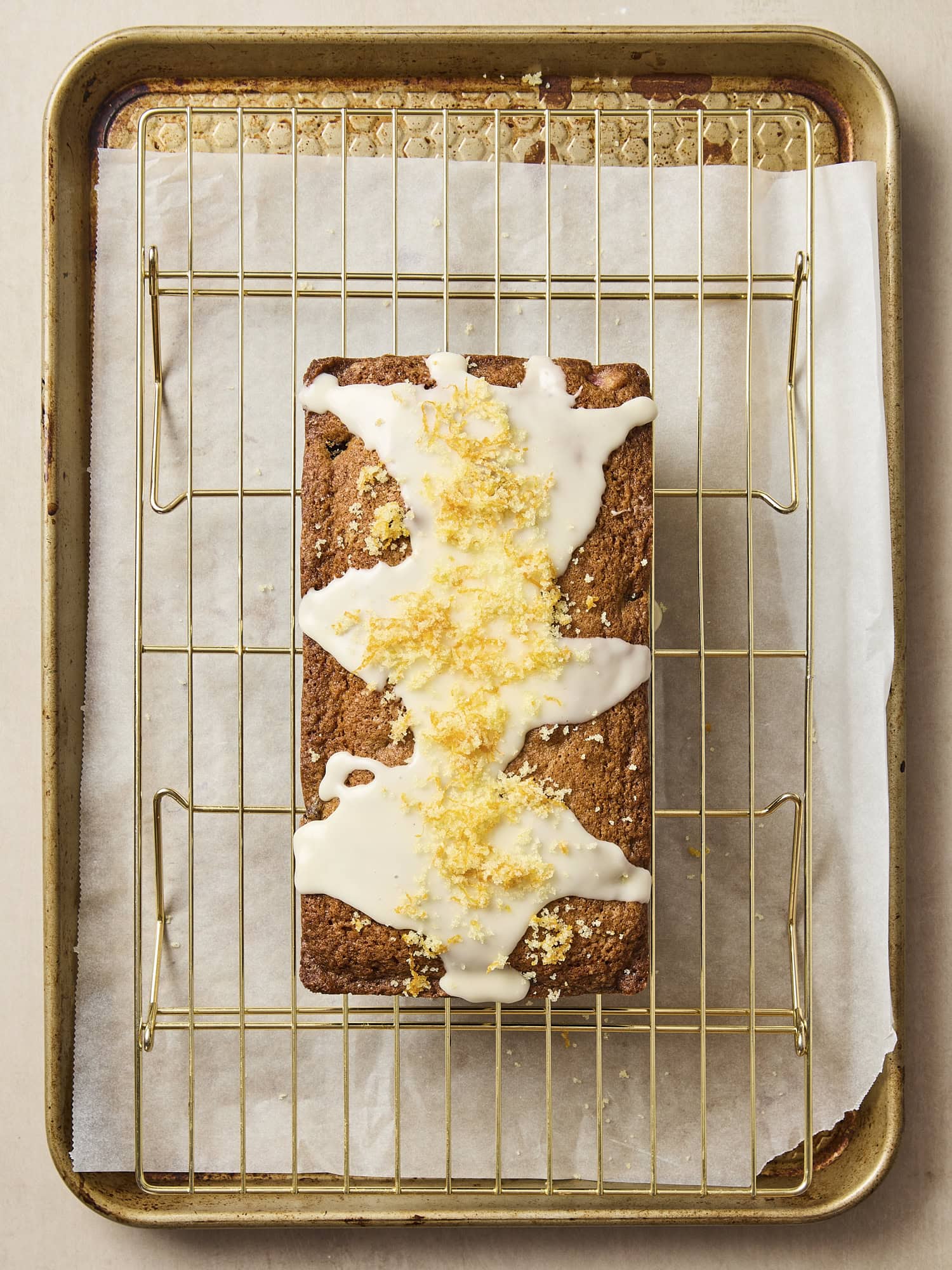 Orange zest sprinkled on top of glaze on pound cake.