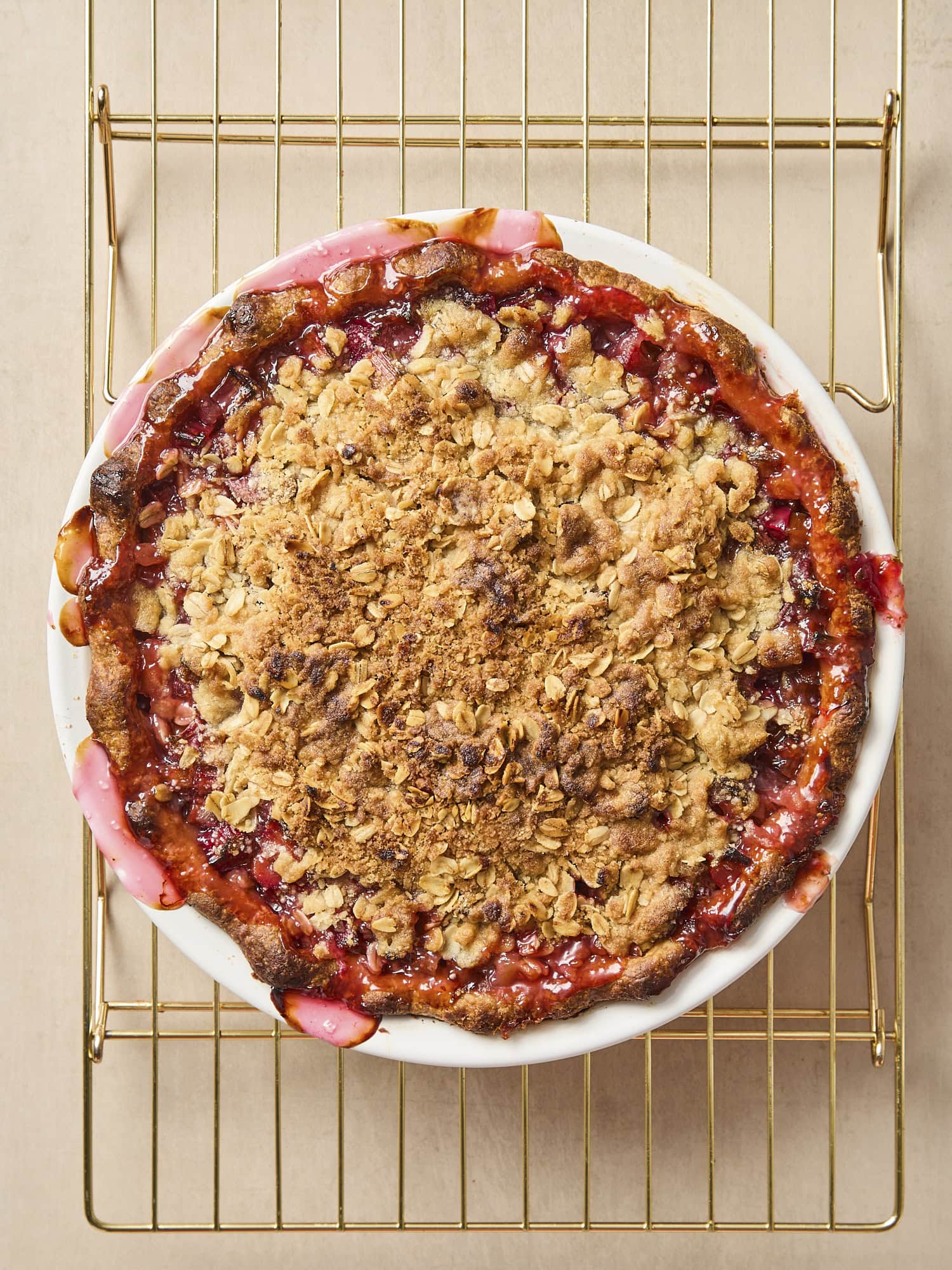 Baked rhubarb pie on cooling rack.
