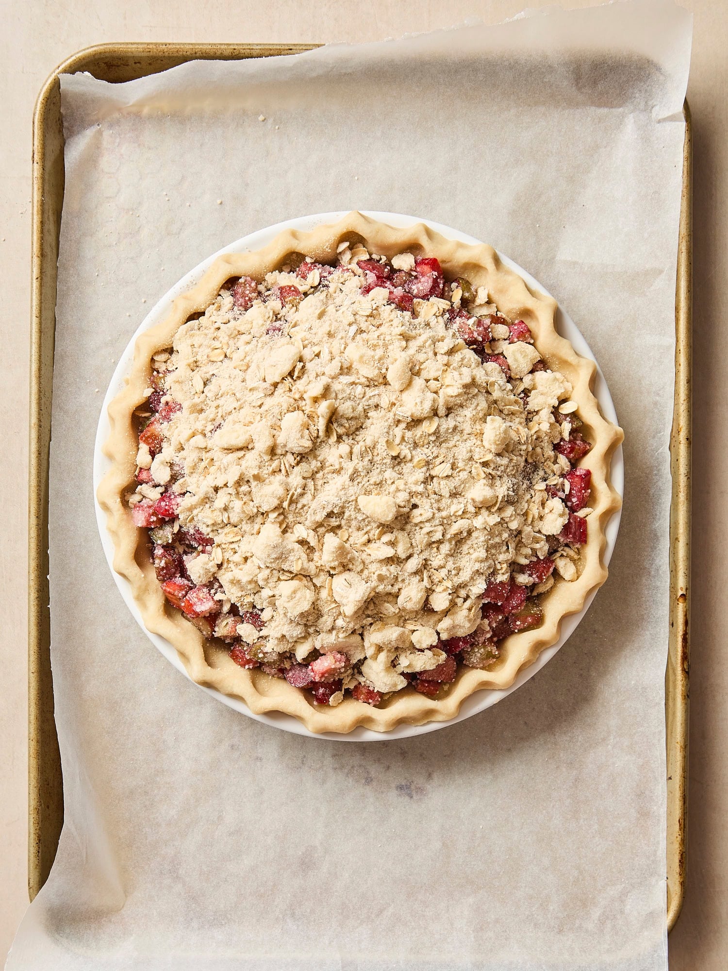 Rhubarb pie with streusel topping before being baked.