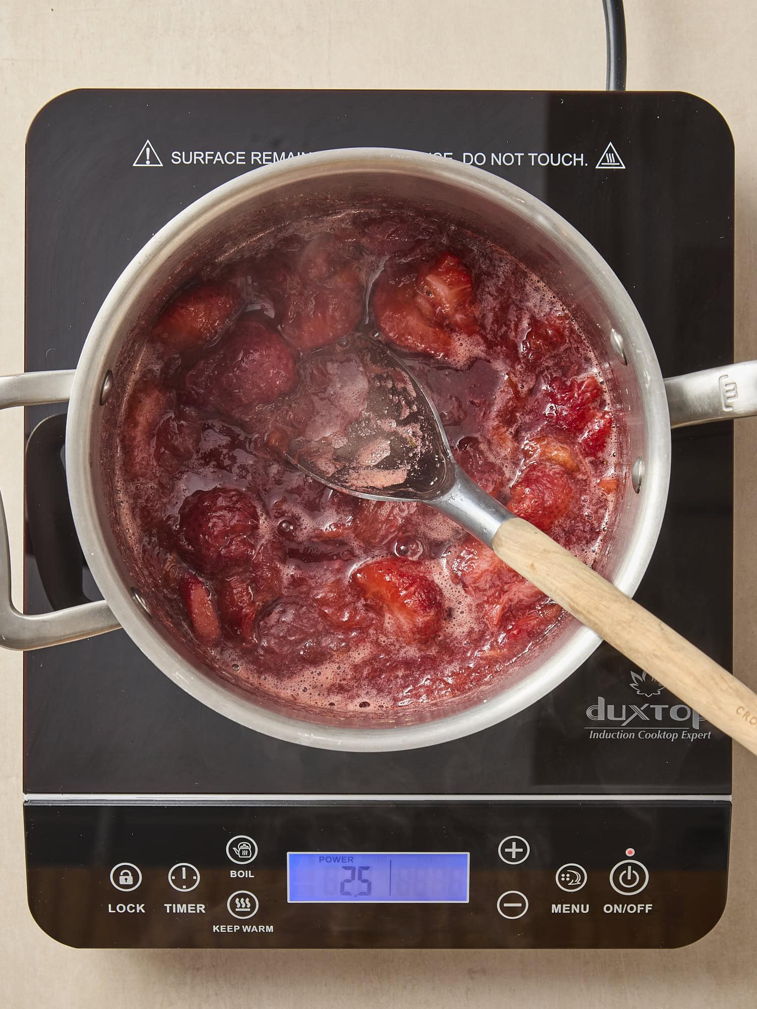 Cooking strawberry rhubarb sauce in pan.