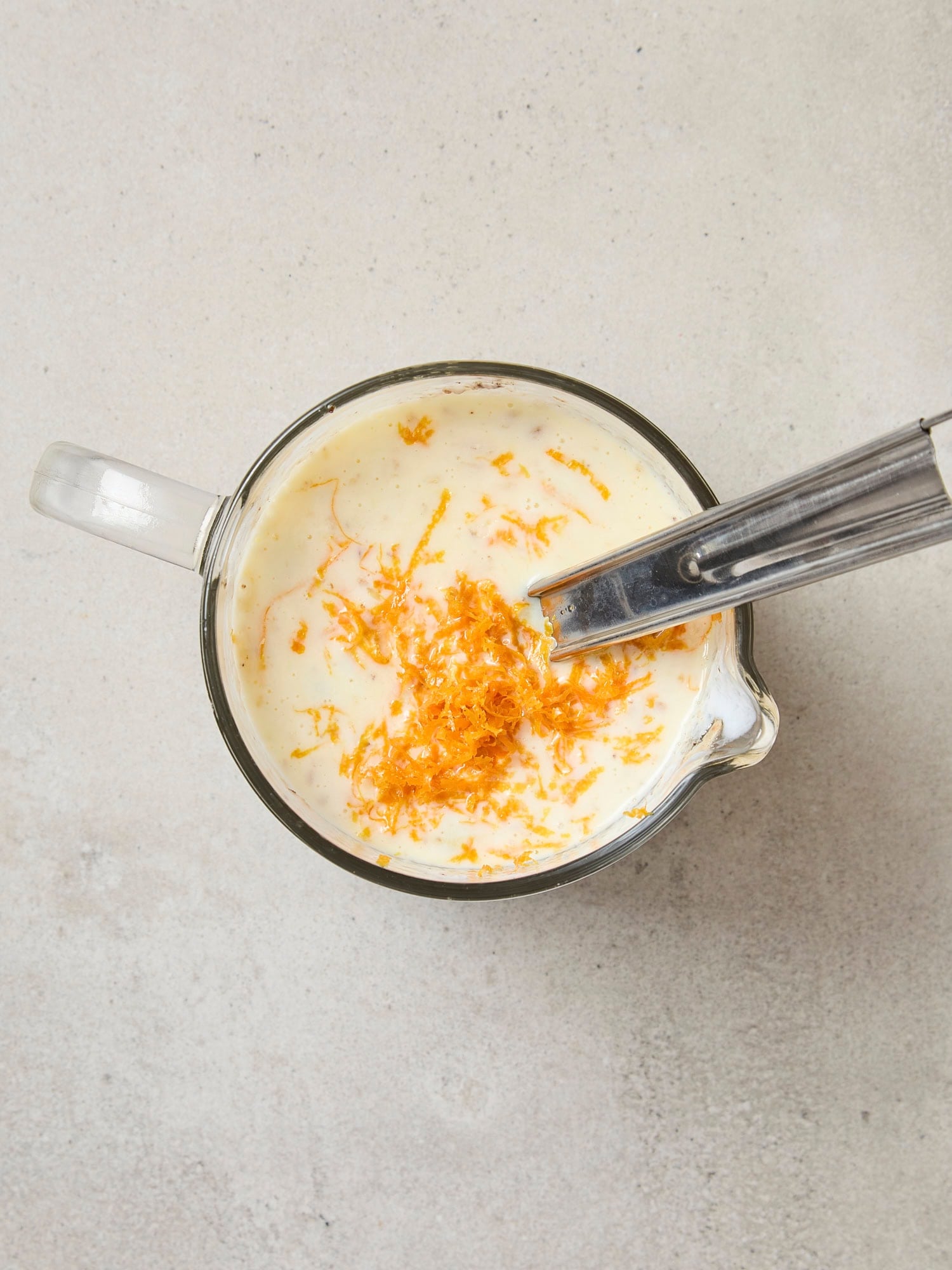 Wet ingredients in measuring cup for pancakes recipe.