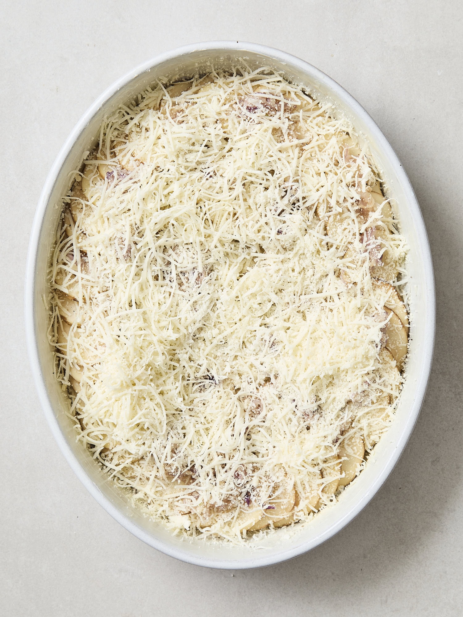 Cheese on top of layered potatoes.