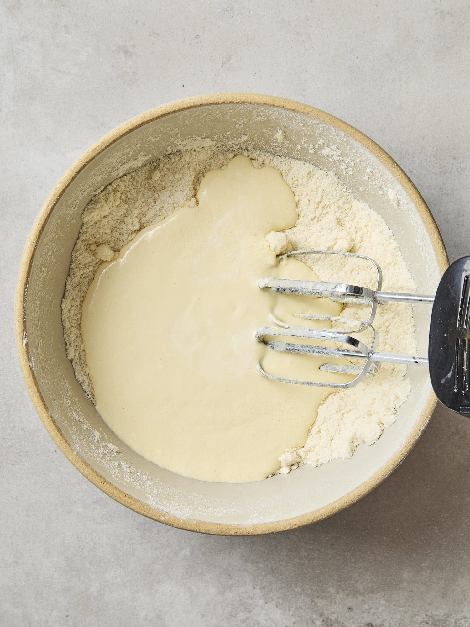 Wet and dry ingredients in a bowl for coffee cake.