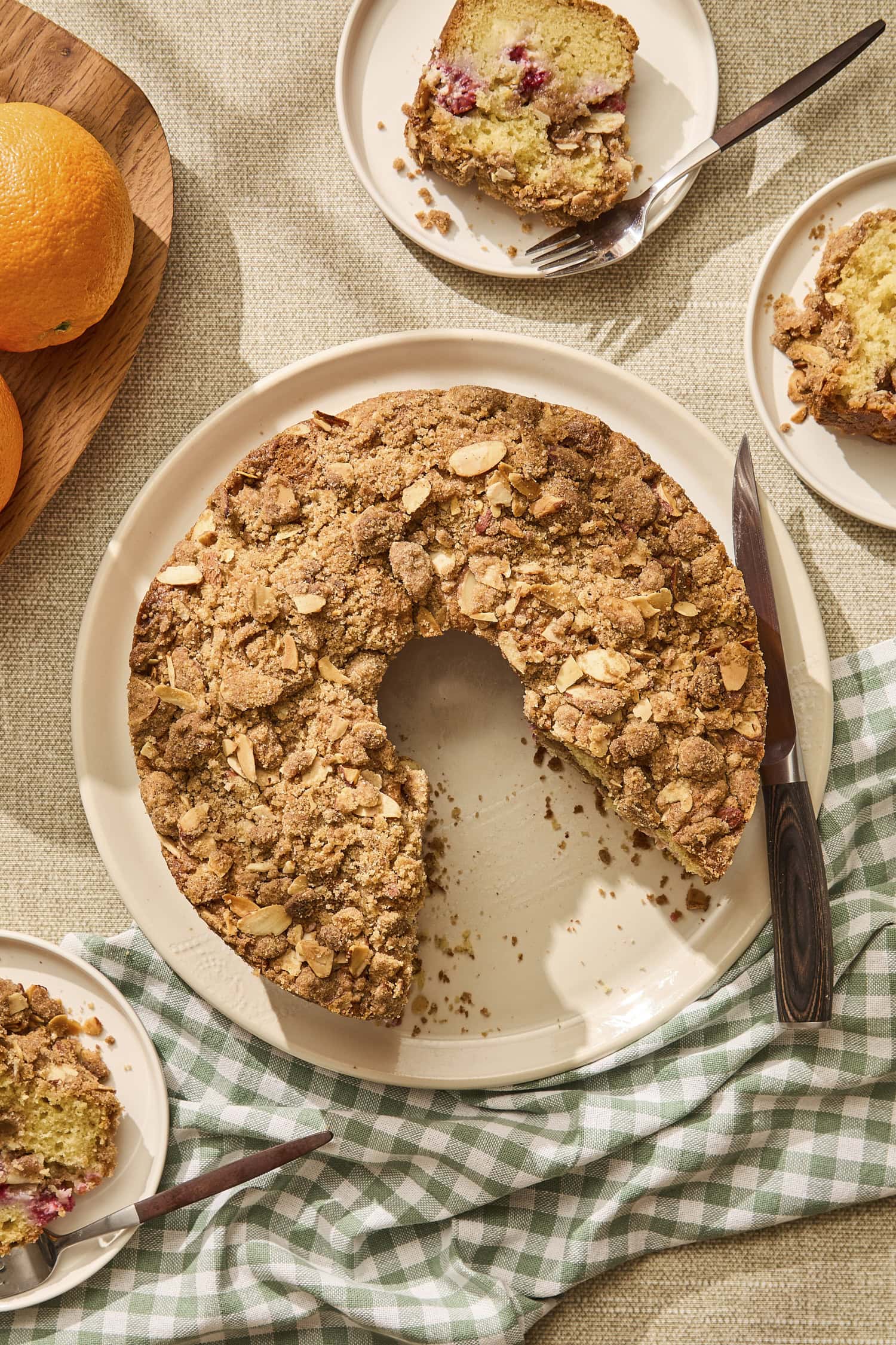 Baked coffee cake with slices taken out on plates.