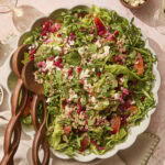 Platter with greens and topped with farro, blood orange segments, pomegranates, feta, and more.