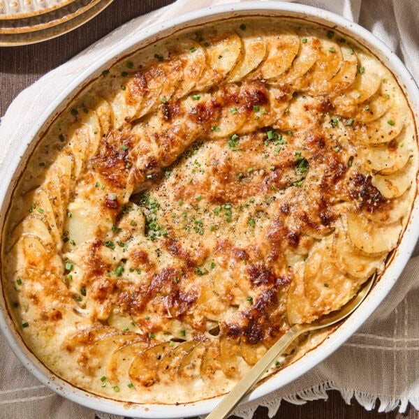 Baking dish with golden brown scalloped potatoes after baking.