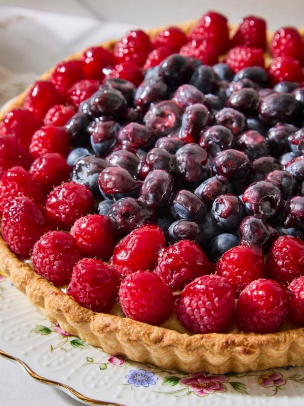 Prepared fresh fruit tart with berries on top.