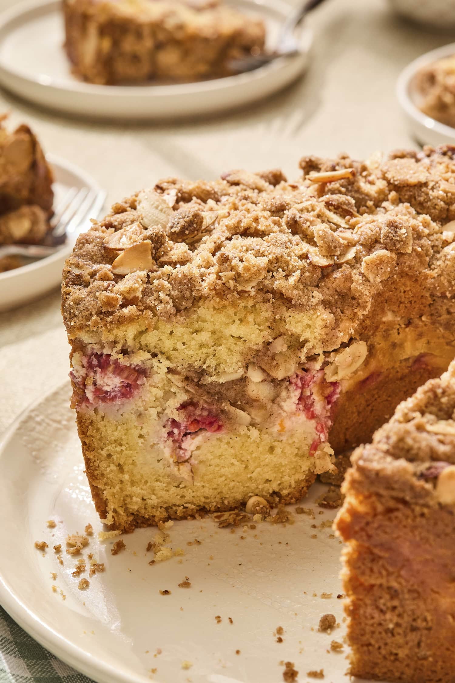 Sliced raspberry orange coffee cake with cream cheese filling layer.