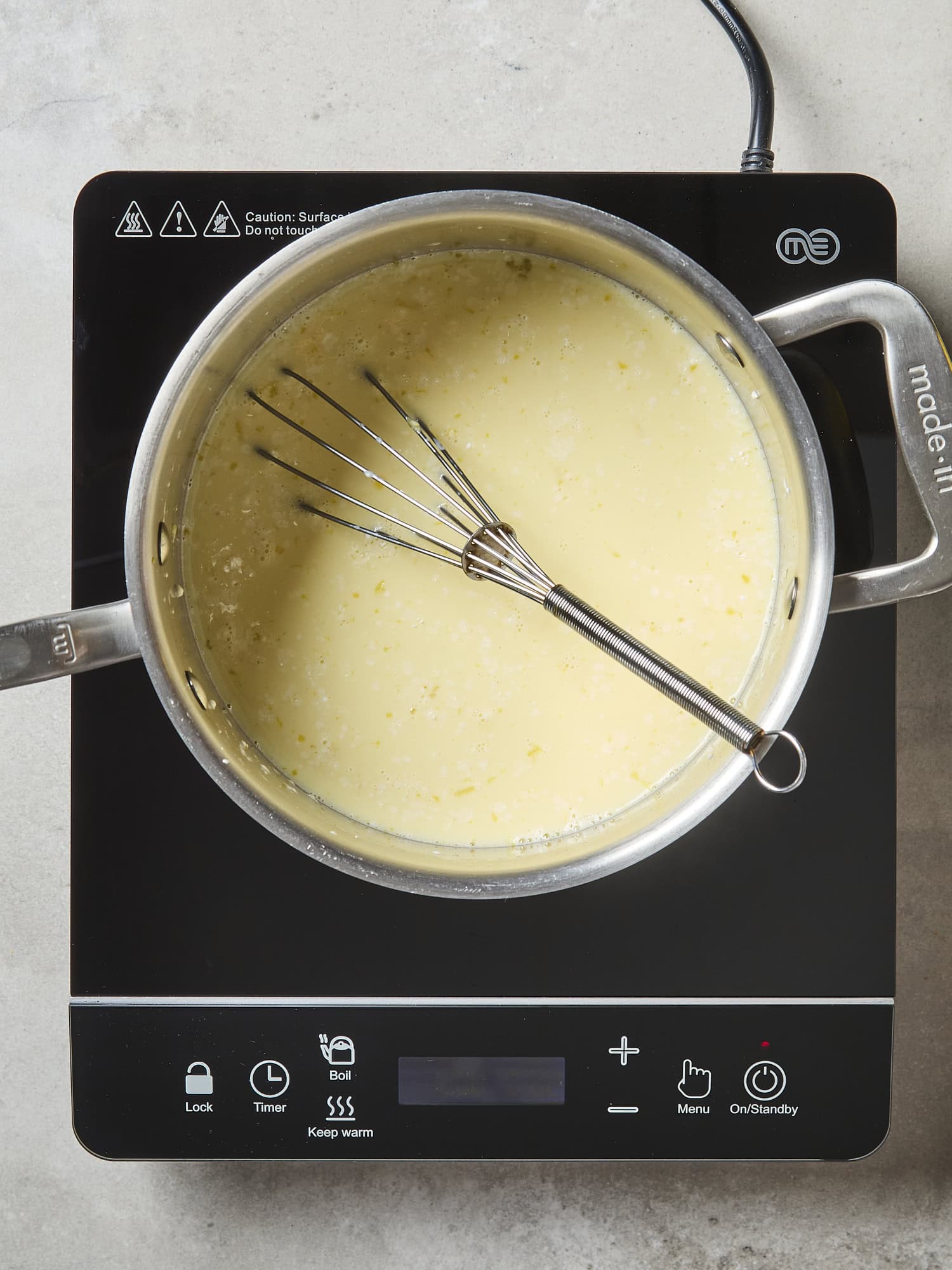 Milk mixture cooking in pan on stove.