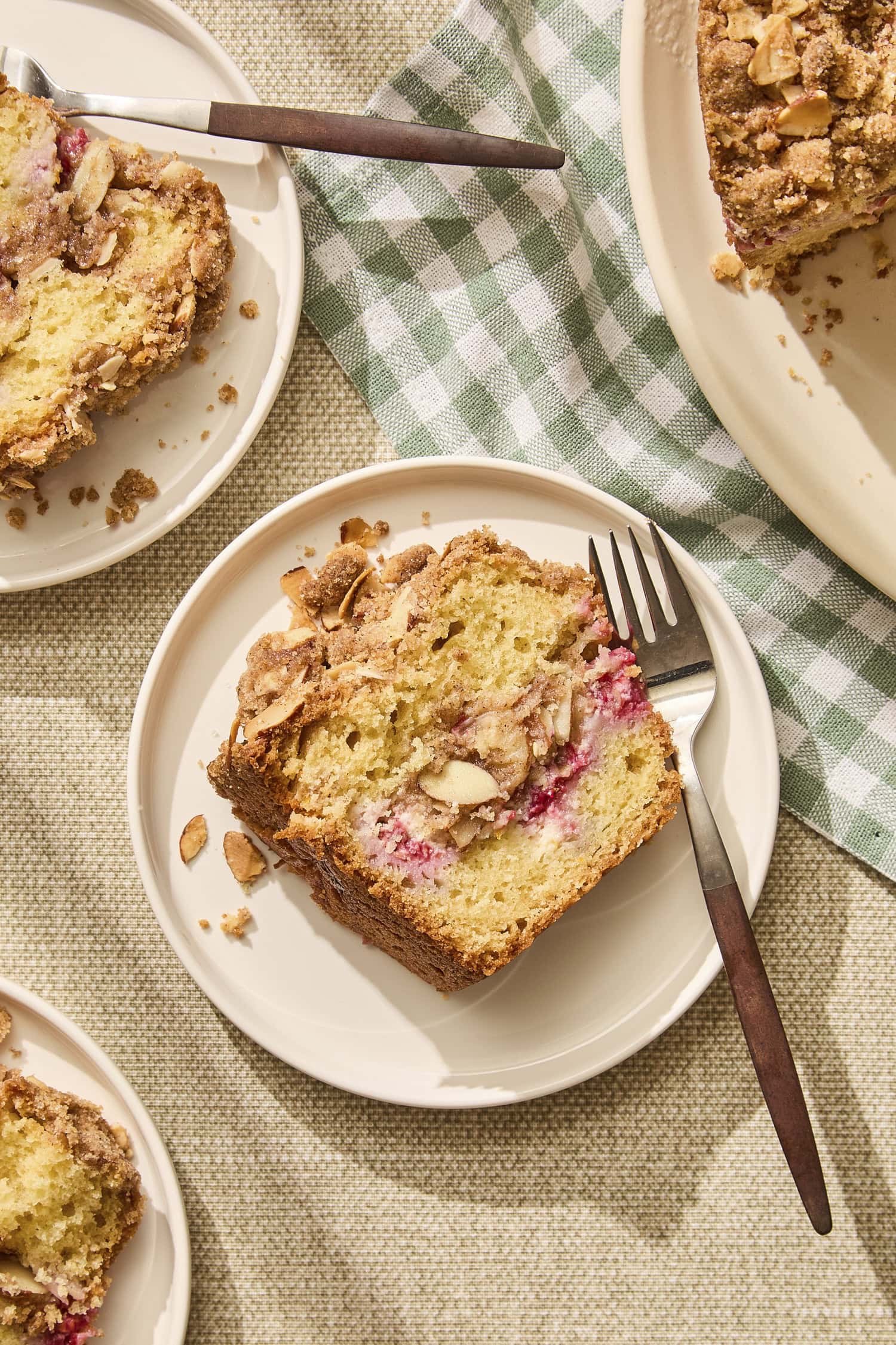 Plates with slices of raspberry orange coffee cake.