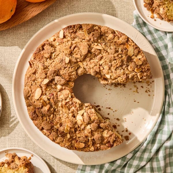 Raspberry orange coffee cake with slices removed.