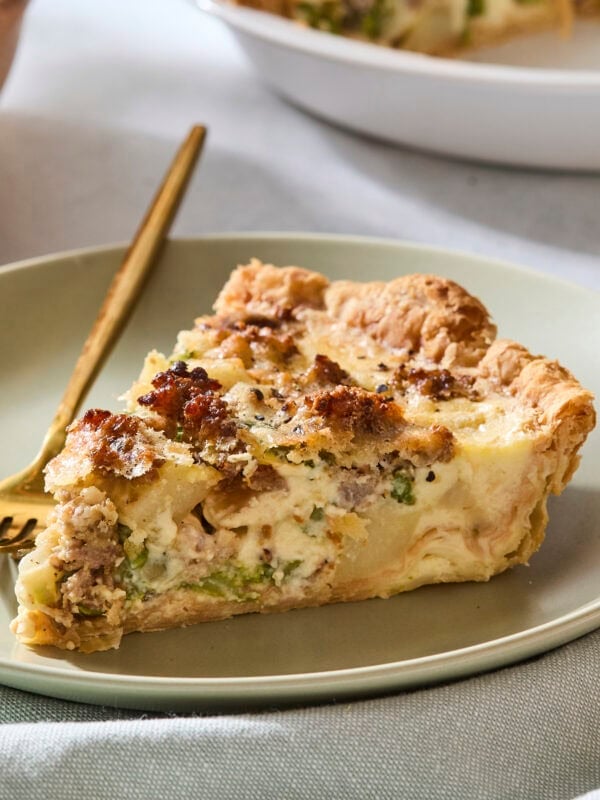 Slice of asparagus quiche on a plate.