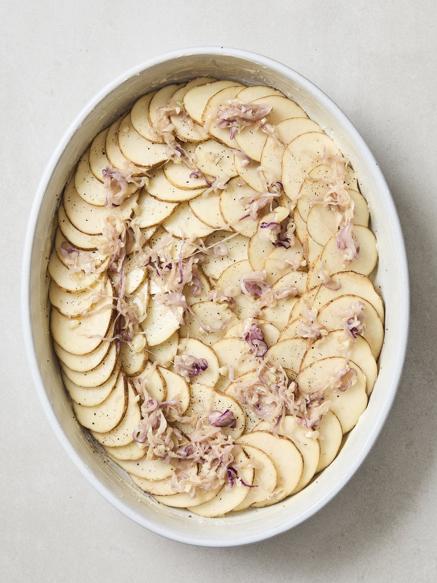 Layered potato slices for casserole.