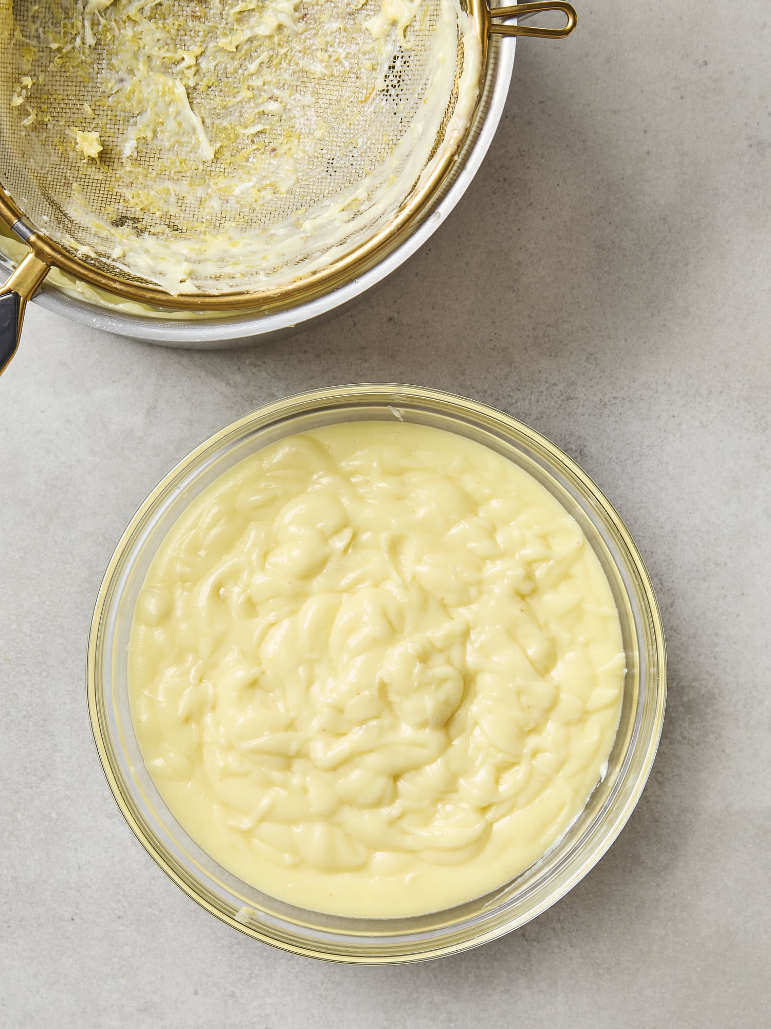 Strained lemon pudding in a glass bowl.