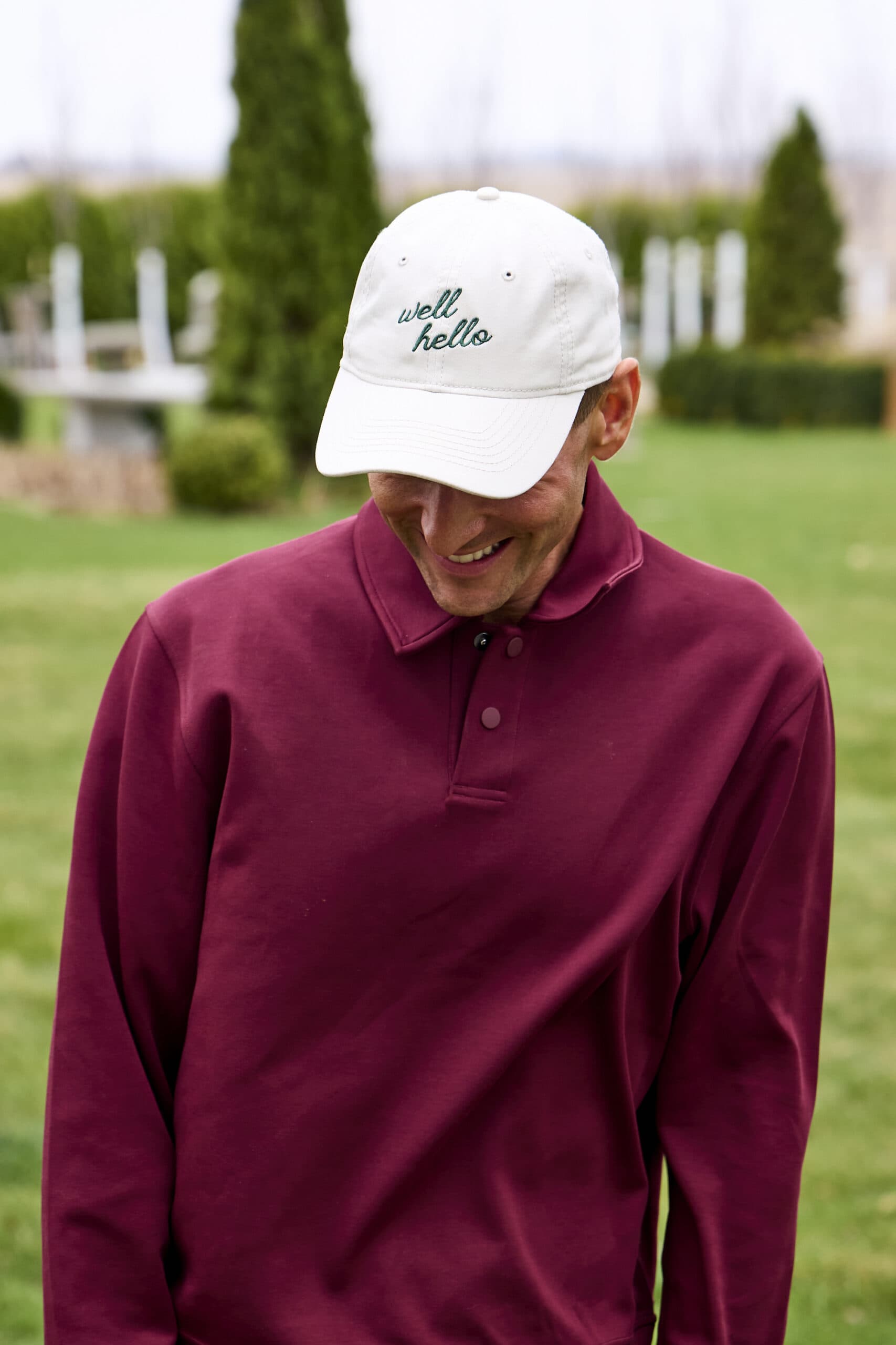 Kaleb wearing white hat with the phrase "well hello".