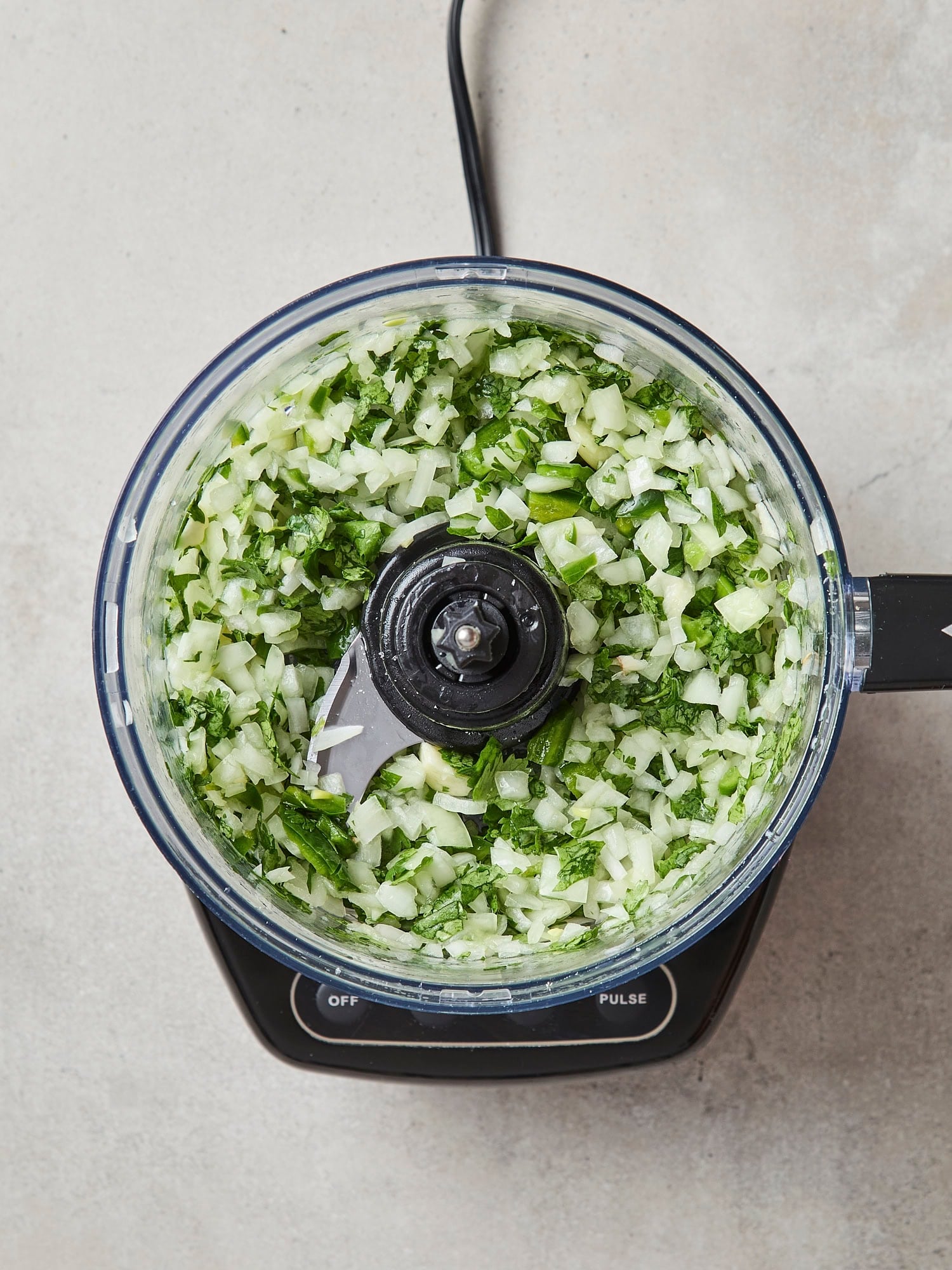Aromatics mixed together in food processor for salsa.