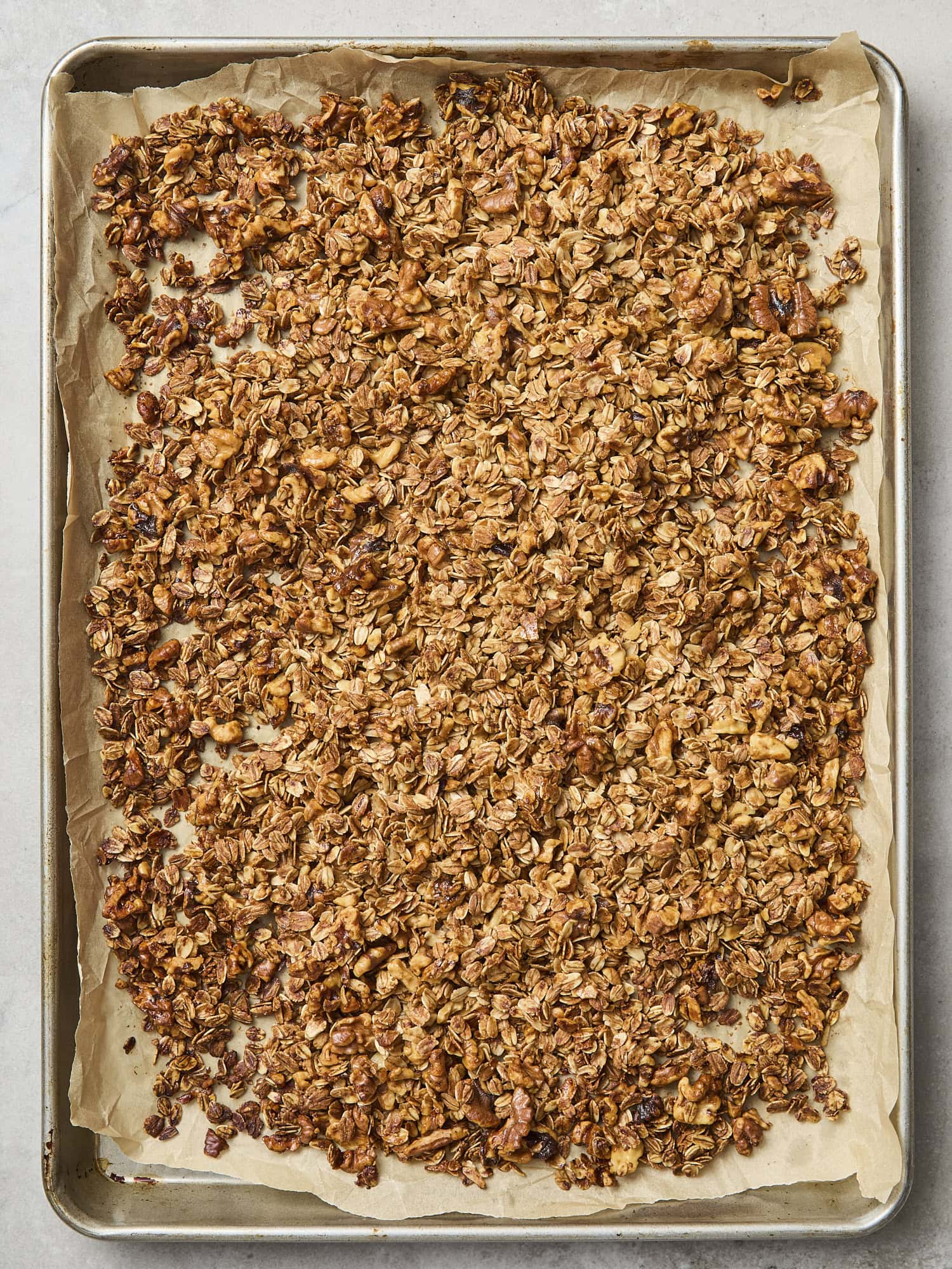 Browned cookie granola on a baking sheet.