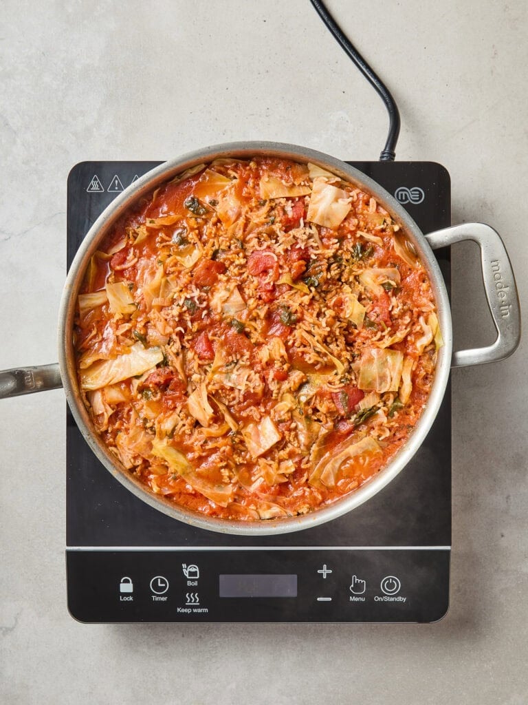 Cabbage roll skillet after cooked down with rice, pork and tomatoes.