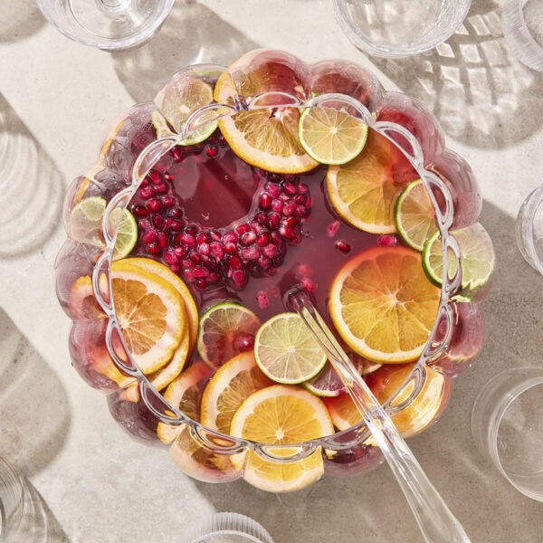 Punch bowl with pomegranate punch and citrus and ice ring.
