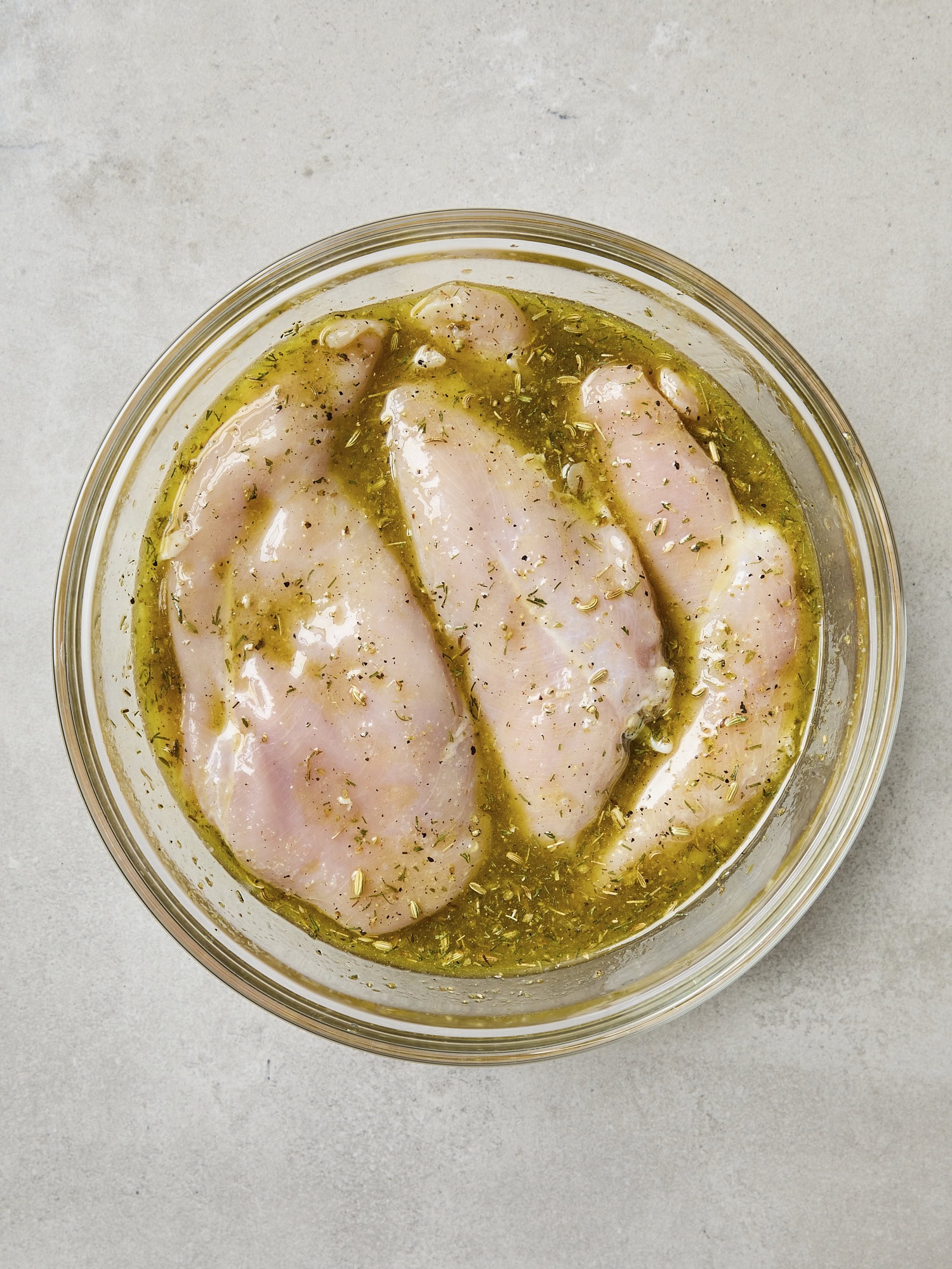 Raw chicken breast submerged in mariade.